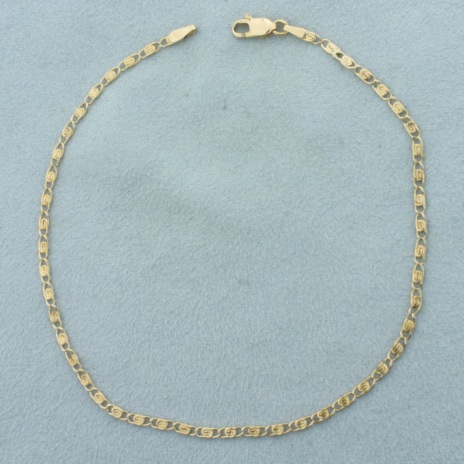 Paperclip Scroll Link Anklet in 14k Yellow Gold: In 14k Yellow Gold. 9 7/8 inches long. 2mm wide. Lobster clasp. 2.8g.