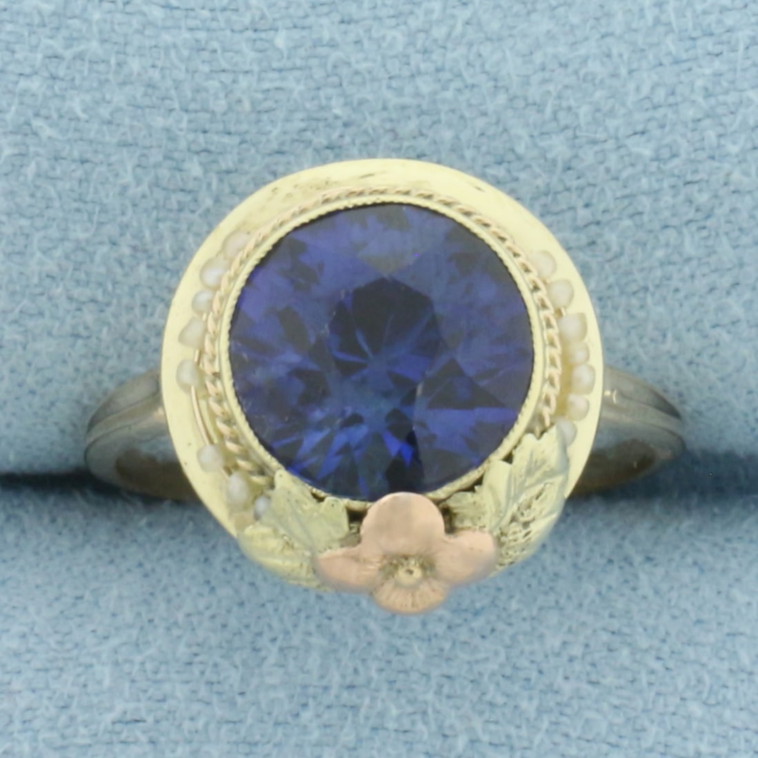 Vintage Lab Sapphire & Seed Pearl Ring in 10k Yellow and Rose Gold: In 10k yellow and rose gold. Contains one 3ct high quality lab Sapphire gemstone with intense color and excellent clarity. Also contains seed pearls that move around bezel. Size 6.5. 3.0g.