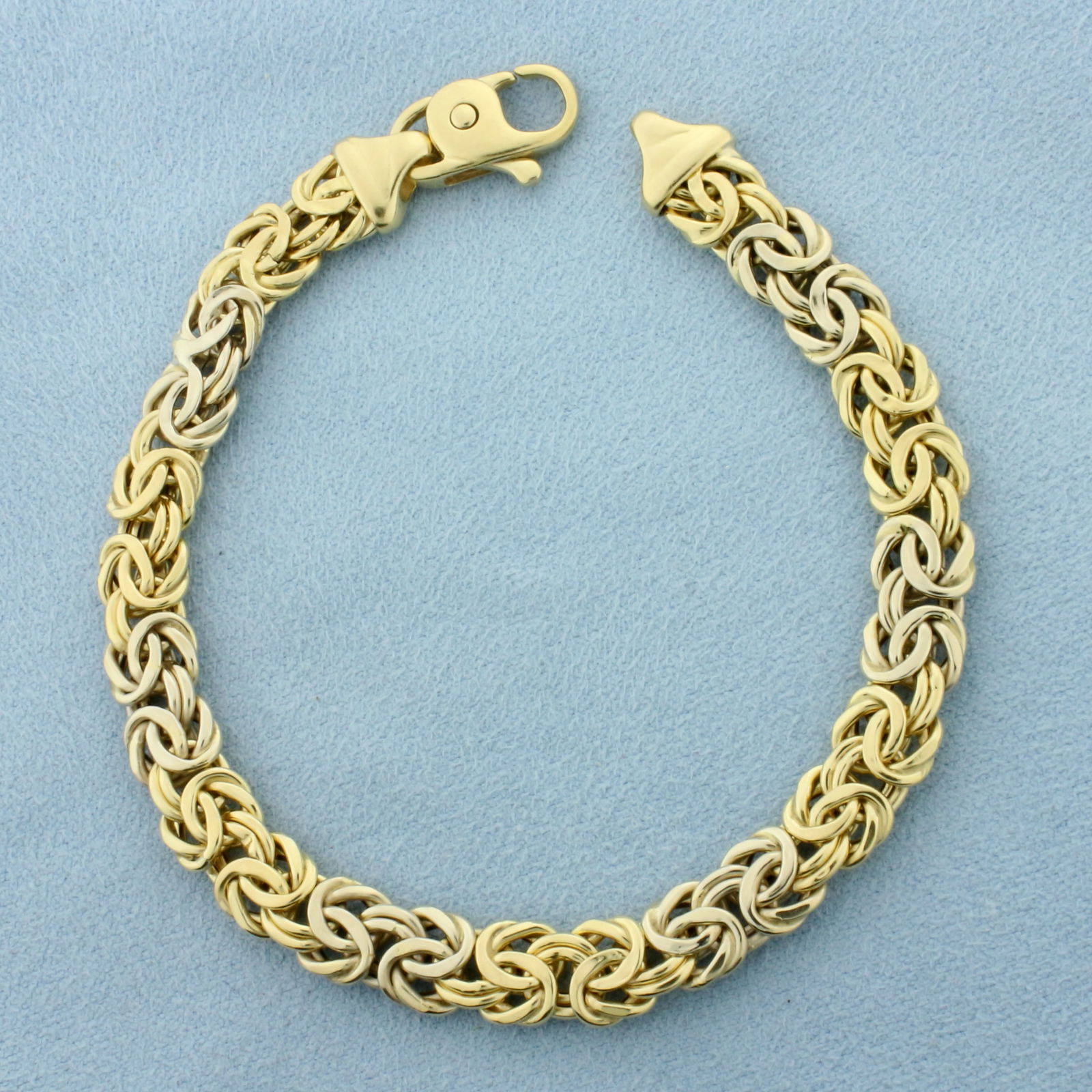 Byzantine Link Bracelet in 18k Yellow and White Gold: In 18k Yellow and White Gold. 7 3/4 inches long. 7.8mm wide. Alternating white and gold links for unique look. Lobster clasp. 11.9g.