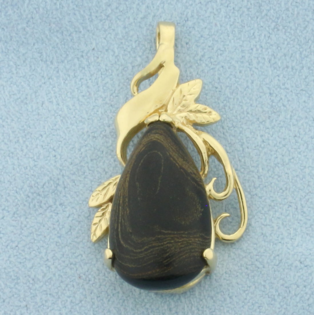 Petrified Wood Pendant in 14k Yellow Gold: In 14k Yellow Gold. Contains one 20x11.6mm high quality petrified wood gemstone. 1 1/4 inch long. 3/4 inch wide. 5.0g.