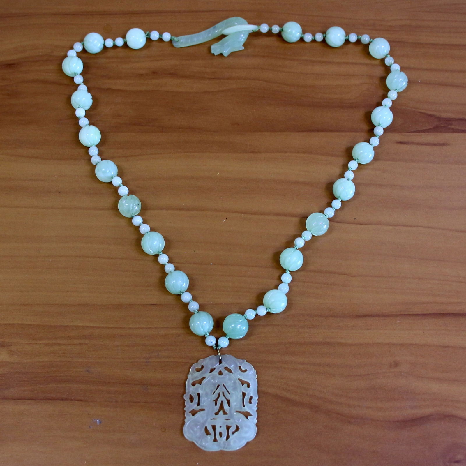 Vintage Carved Jade Bead Necklace: Contains 6mm and 13.5mm high quality carved Jade beads. Dangle drop is 2 inches by 1 5/8 inch. 28 inches long. Hand knotted. 105.9g.