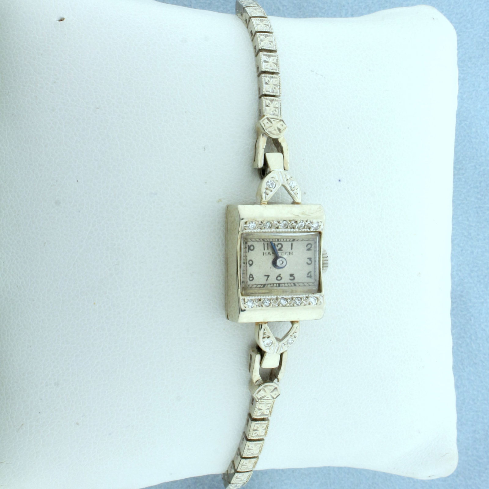 Vintage Ladies Hampden Diamond Watch in Solid 14K White Gold: Band and Case in Solid 14K White Gold. Movement was rebuilt with quartz movement for high precision. Case is 17mm x 13.5mm. Contains ten high quality .01ct diamonds, VS clarity/H color. 6 3/4 inch lon