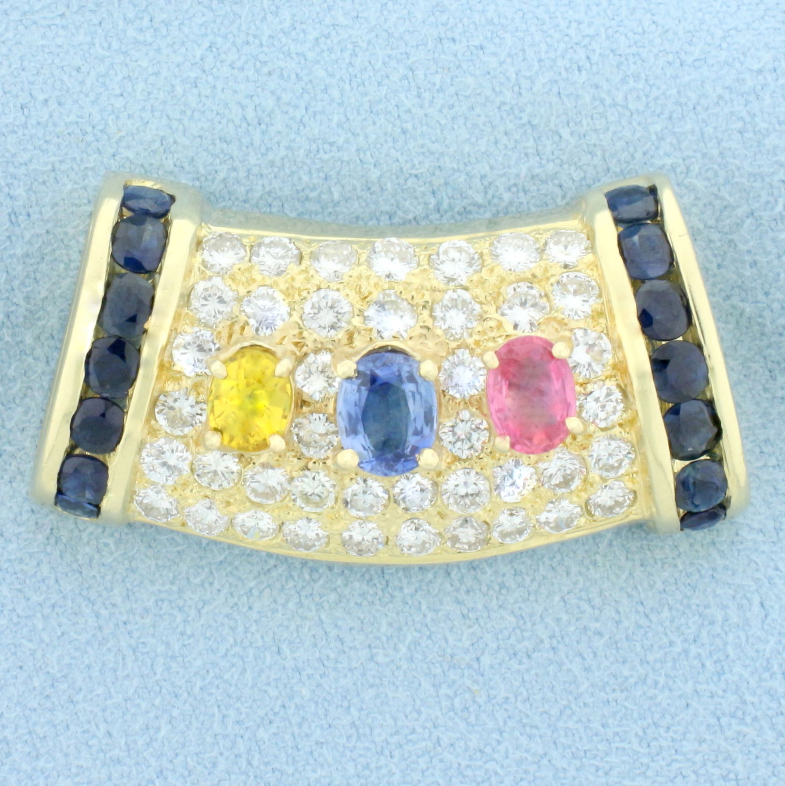 Designer Sapphire and Diamond Pendant Slide in 14K Yellow Gold: In 14K Yellow Gold. Contains one blue, pink, and yellow high quality natural 5 to 6mm oval sapphires with vibrant color and excellent clarity. Also contains fourteen high quality natural 3mm Blue Sapp