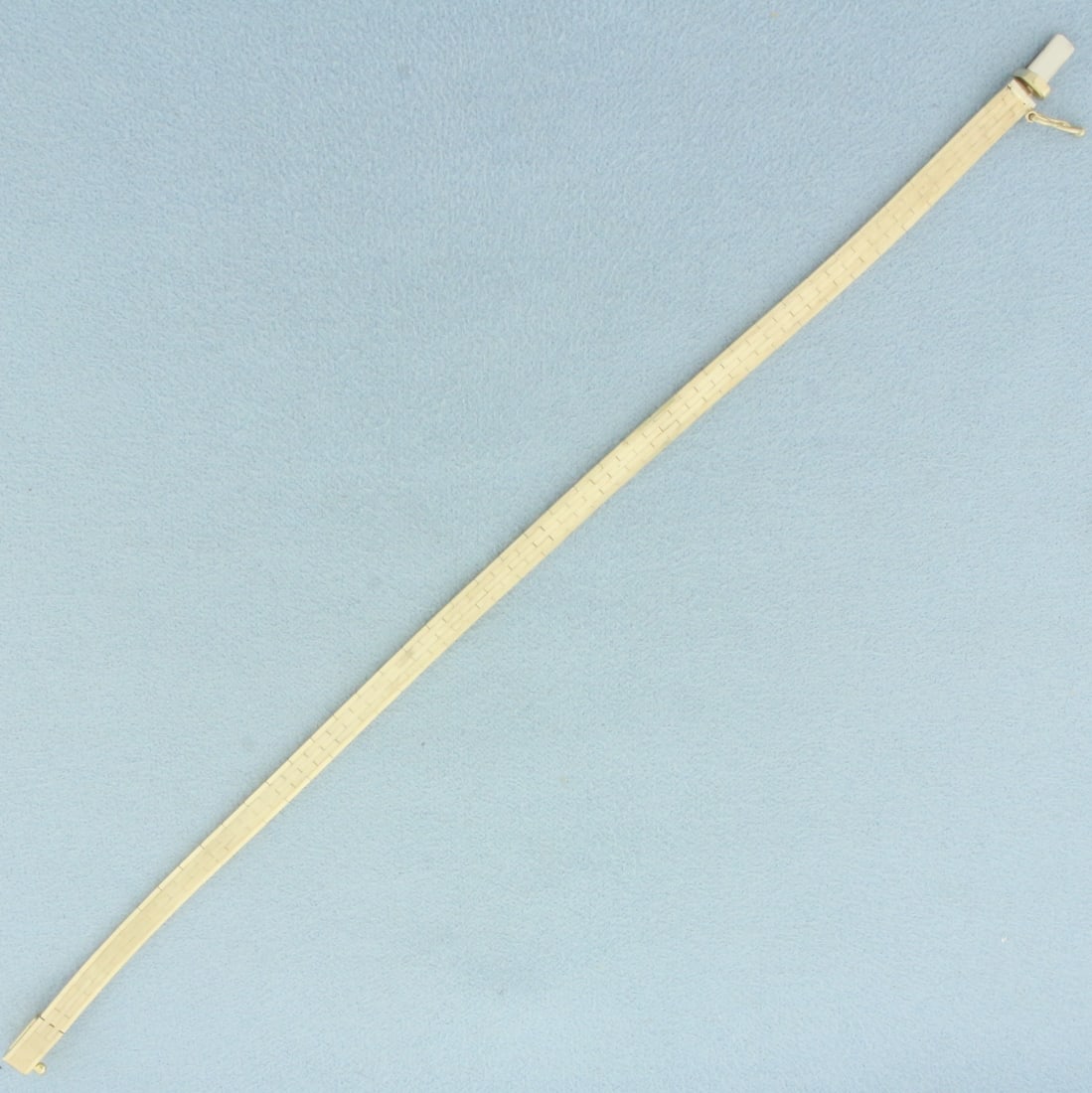 Italian Brick Track Link Bracelet in 14k Yellow Gold: In 14k yellow gold. Made in Italy. 7 inches long x 4.2mm wide. Safety clasp. 11.7g.