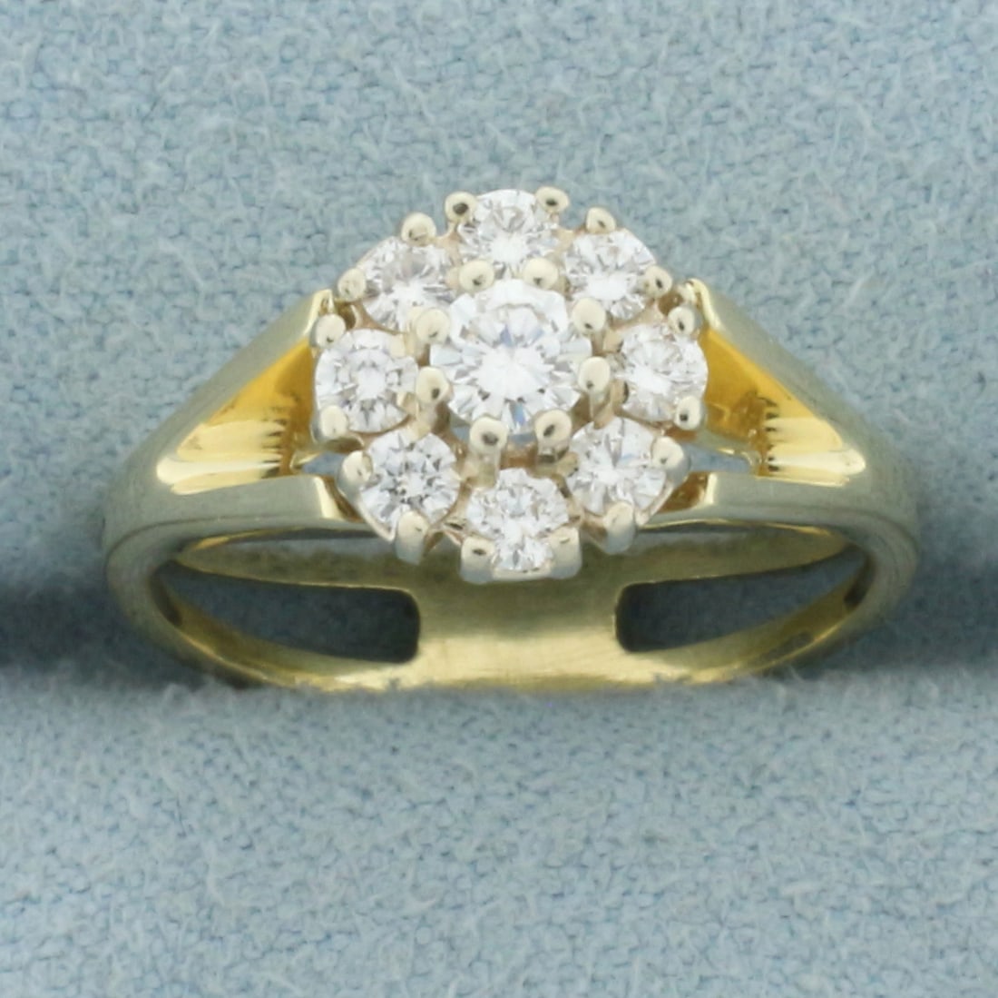 Flower Design Split Shank Diamond Ring in 14k Yellow Gold: In 14k yellow gold. Contains one high quality round brilliant 1/5ct diamond, VS clarity/F color. Also contains eight high quality .05ct round brilliant diamonds of similar high quality. Size: 4.5. 3.3