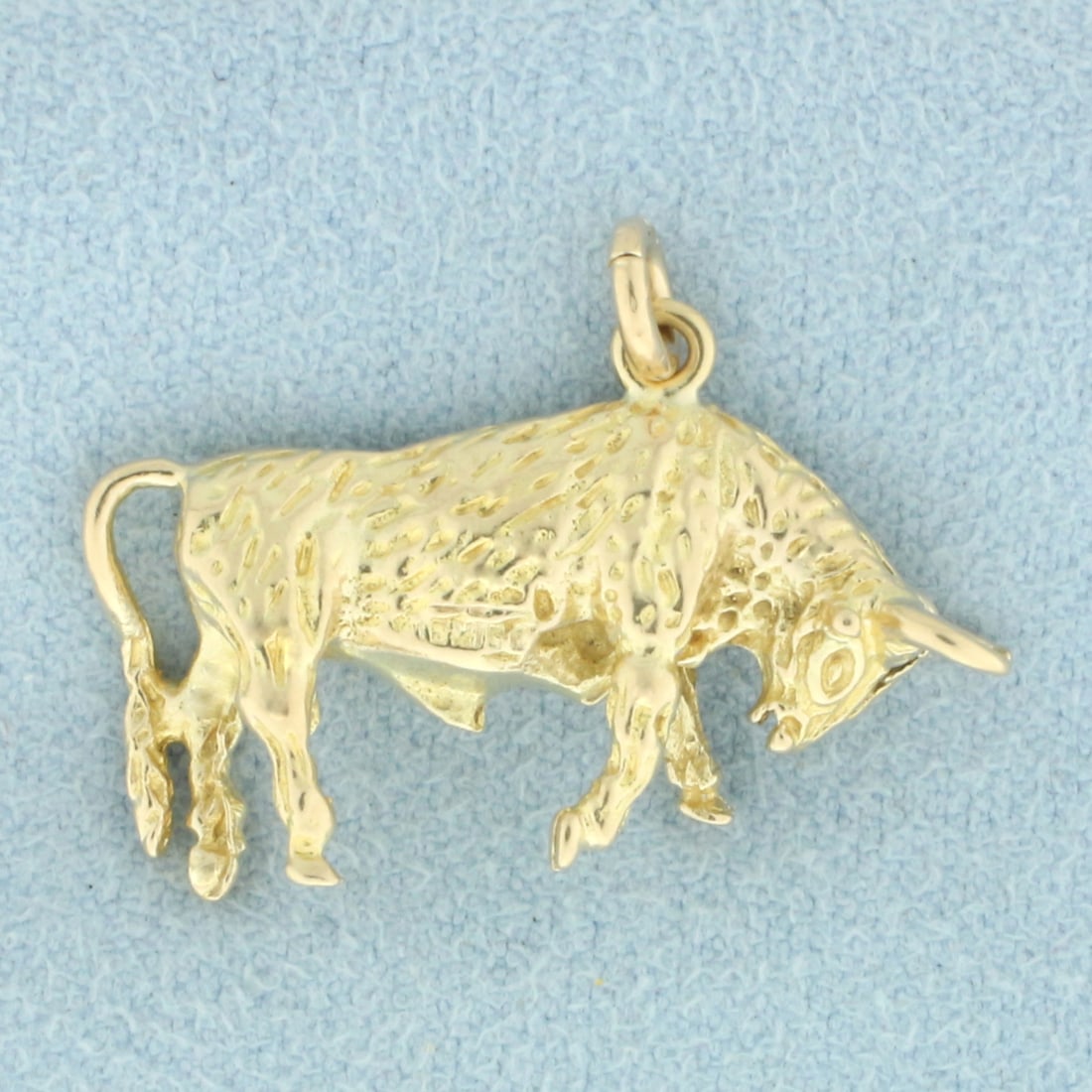 Bull Charm or Pendant in 10k Yellow Gold: In 10k yellow gold. 5/8 inch long (including jump ring) and 1 inch wide. 6.1g.