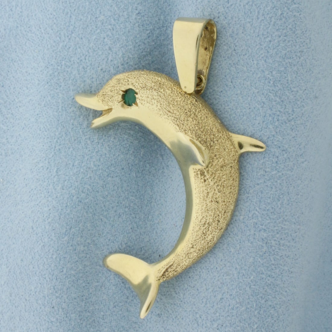 Dolphin Pendant Emerald Eye in 14k Yellow Gold: In 14k yellow gold. 1.75 inches long (including bail). 1.25 inches wide. 2.75mm high quality natural Emerald for eye. 8.0g.