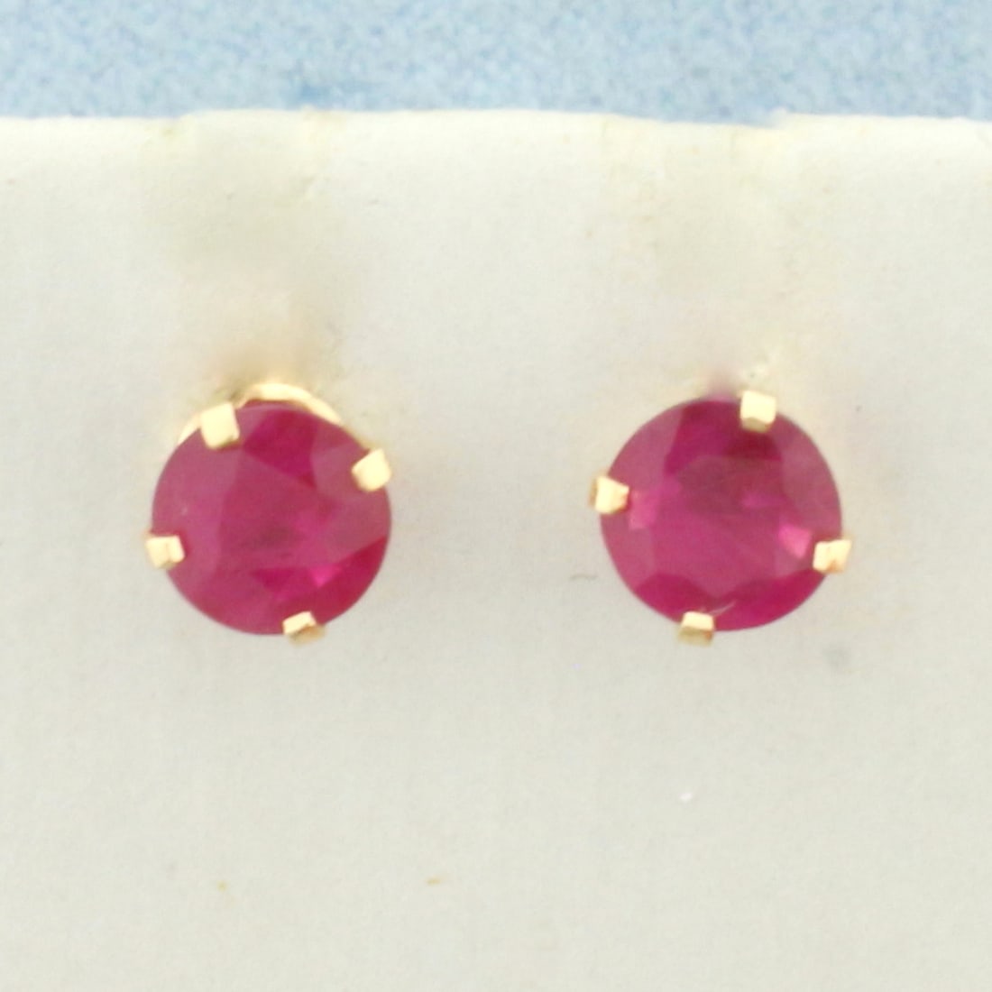 Ruby Stud Earrings in 14k Yellow Gold: In 14k Yellow Gold. Contains two high quality natural 5mm Ruby gemstones, approximately 3/4ct TW, with vibrant color. Friction backs. .7g.