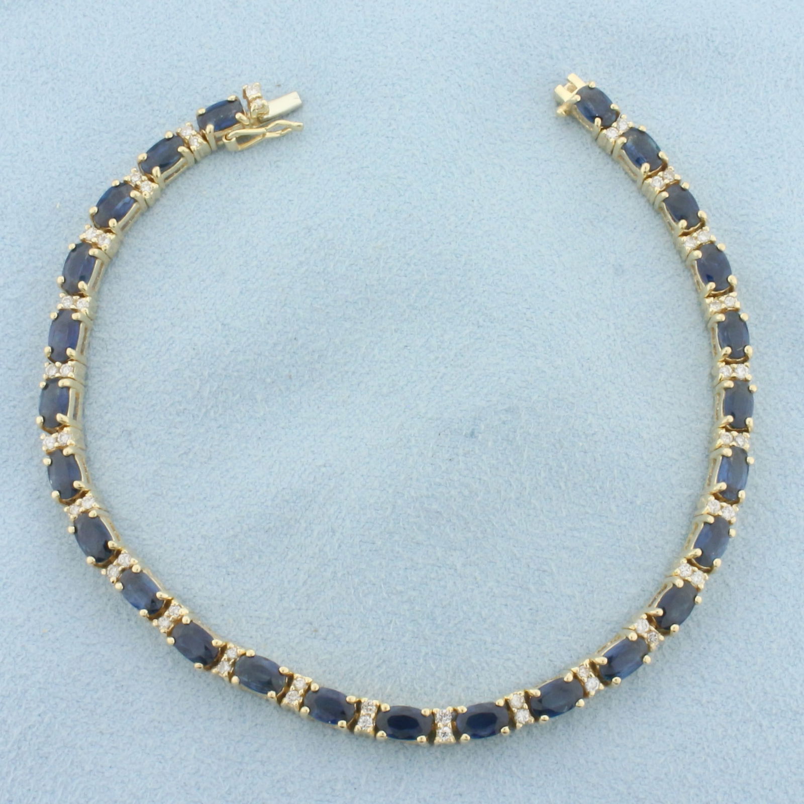 Sapphire and Diamond Tennis Bracelet in 14k Yellow Gold: In 14k Yellow Gold. Contains twenty-five high quality natural 5mm Sapphire gemstones, approximately 6.25ct TW, with deep blue color and excellent clarity. Also contains fifty .01ct diamonds, SI clarit