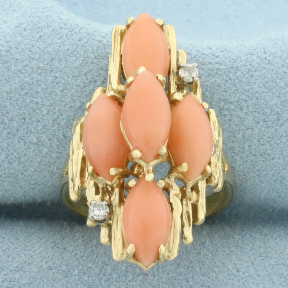 Vintage Angel Skin Coral and Diamond Ring in 14k Yellow Gold: In 14k Yellow Gold. Contains five high quality 10mm Angel Skin Coral gemstones with beautiful pink color. Also contains two .02ct high quality diamonds, SI clarity/H color. 1 1/8 inches wide at top of