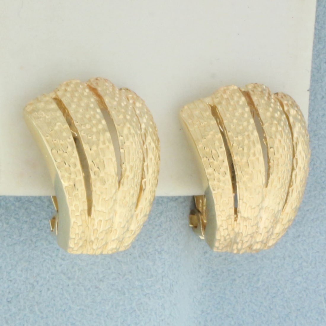 Textured Fan Design J Hoop Earrings in 14k Yellow Gold: In 14k Yellow Gold. 3/4 inch long. 5/8 inch wide. For Pierced Ears. Omega style post backs. 10.4g.