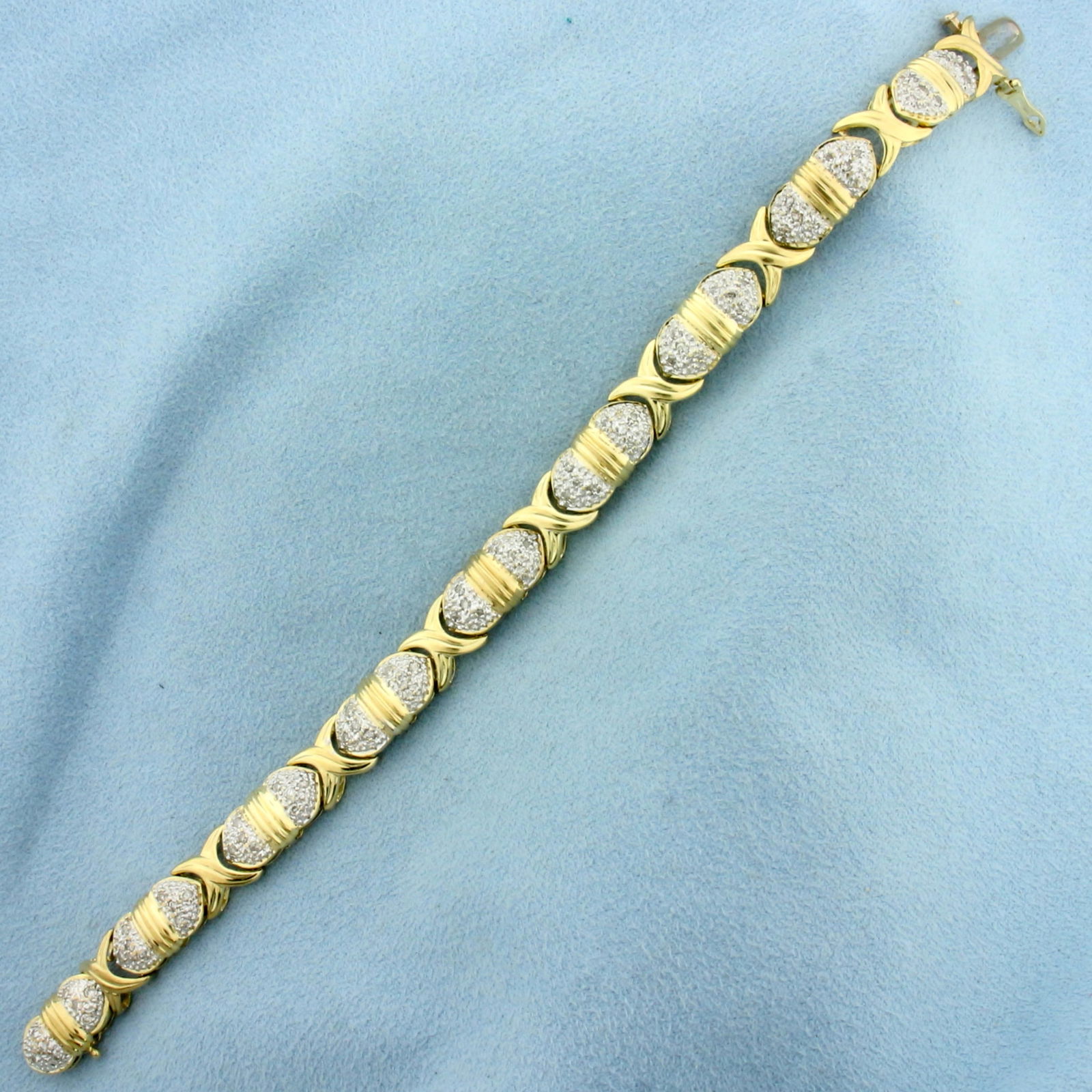 Pave Diamond X and O Hugs and Kisses Bracelet in 10k Yellow Gold: In 10k Yellow Gold. Contains seventy-two .01ct high quality 1/2pt diamonds. 7 1/8 inches long. 1/4 inch wide. Concealed closure with safety latch. 14.8g.