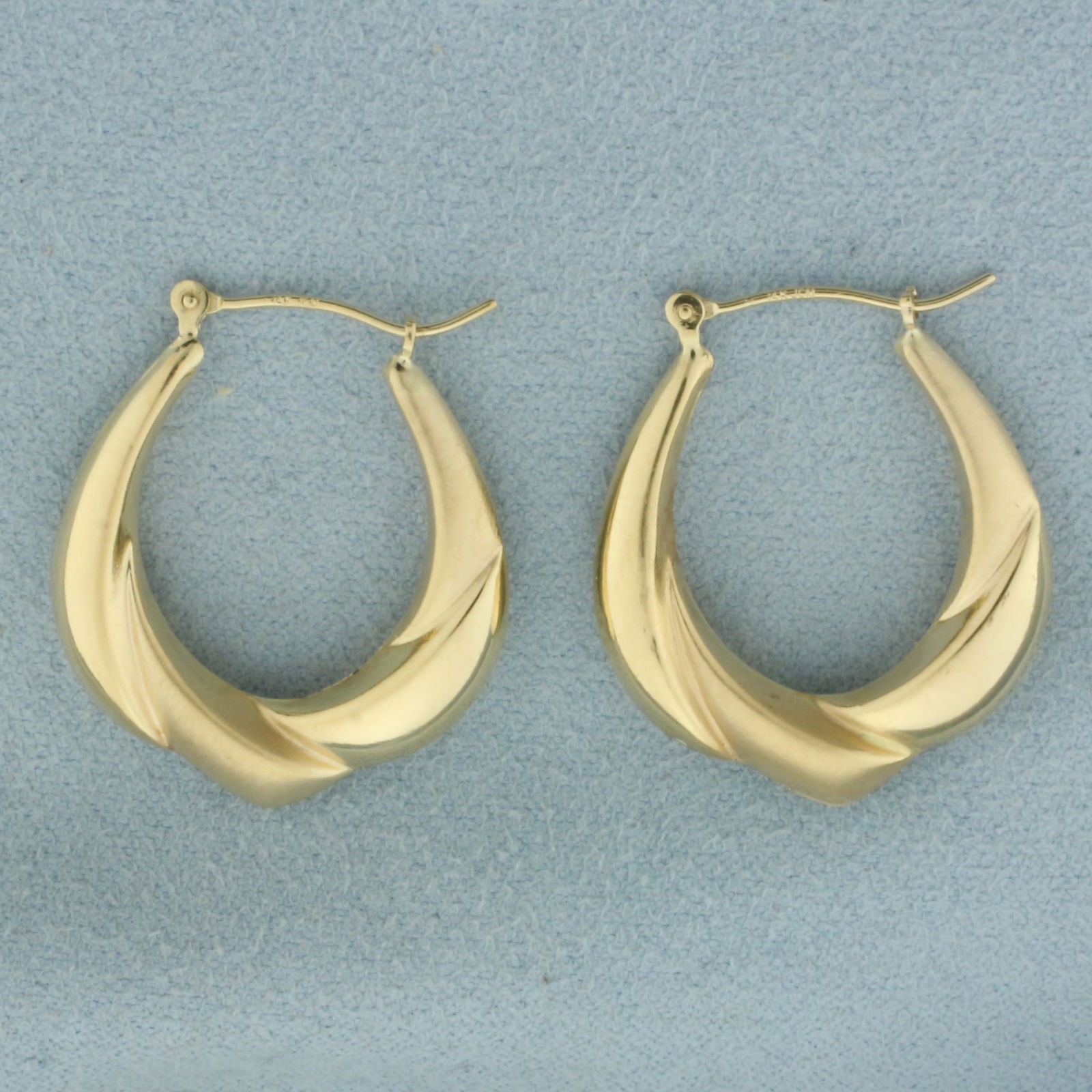 Satin and High Polish Hoop Earrings in 14k Yellow Gold: In 14k Yellow Gold. 1 1/8 inch long. 7/8 inch wide. Both satin and high polish finish for unique look. Leverbacks. 2.0g.