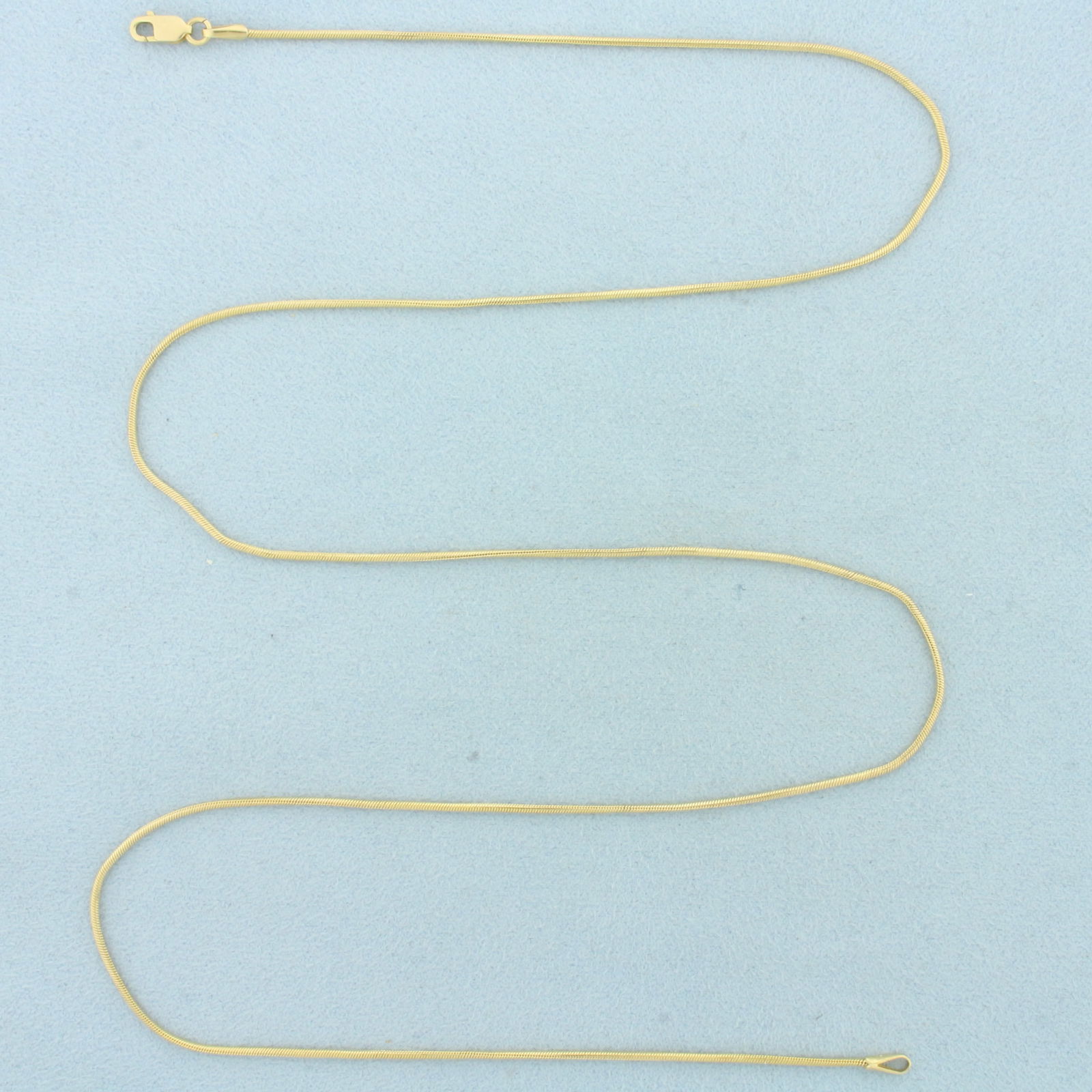 Italian 23 Inch Snake Link Chain Necklace in 14k Yellow Gold: In 14k Yellow Gold. 23 inches long. 1.2mm wide. Snake link. Made in Italy. Lobster clasp. 5.4g.