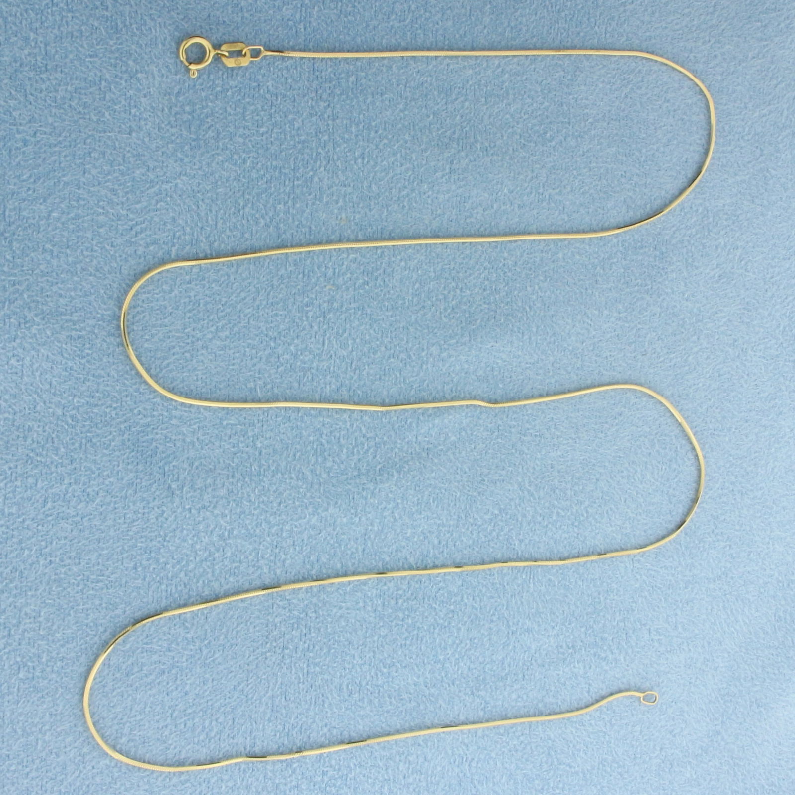 Italian 20 Inch Snake Link Chain Necklace in 14k Yellow Gold: In 14k Yellow Gold. 20 inches long. 0.7mm wide. Made in Italy. Spring clasp. 2.3g.