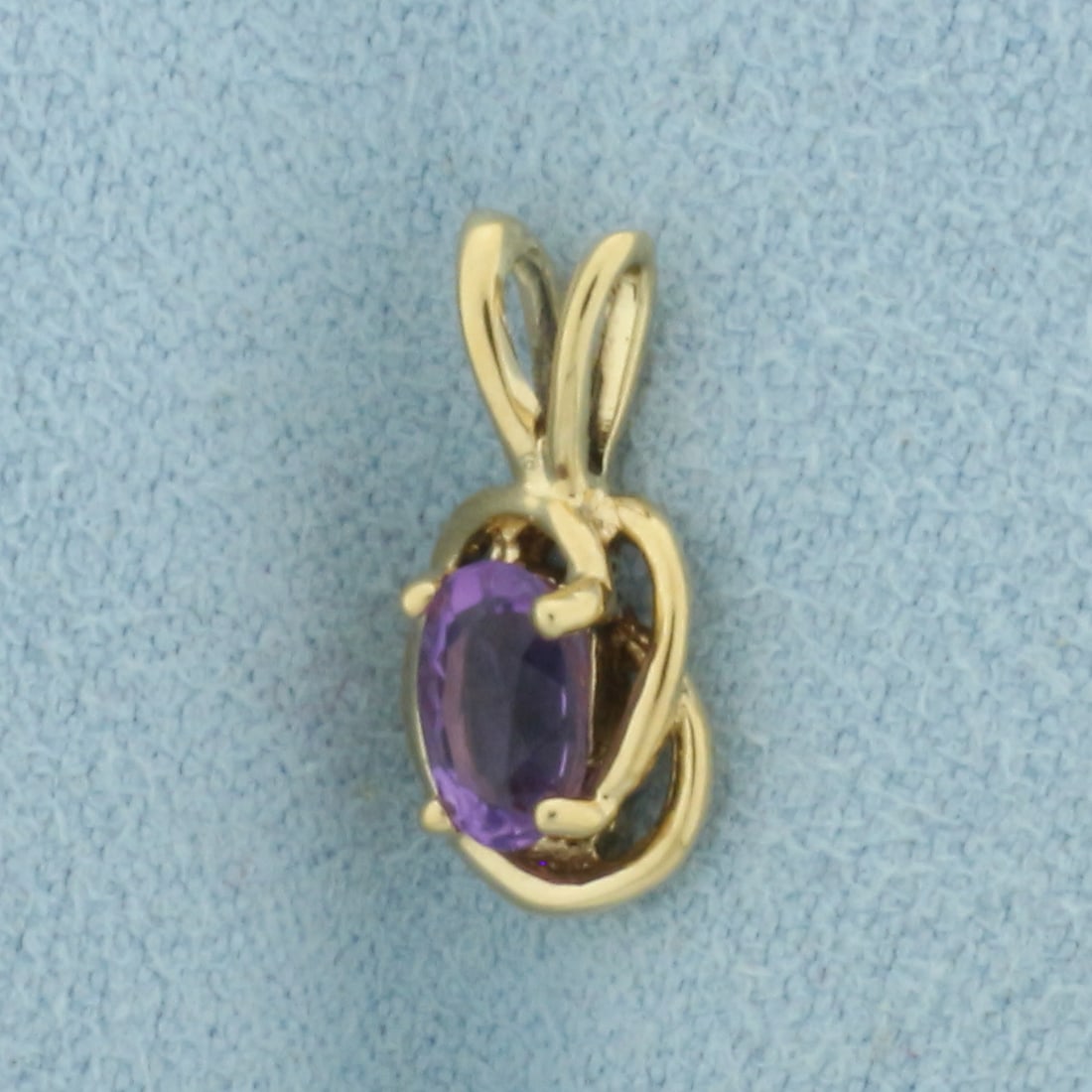 Amethyst Pendant in 14k Yellow Gold: In _k Yellow Gold. Contains one 4x6mm high quality natural Amethyst gemstone with vibrant color and excellent clarity. 1/2 inch long. 1/4 inch wide. 1.0g.