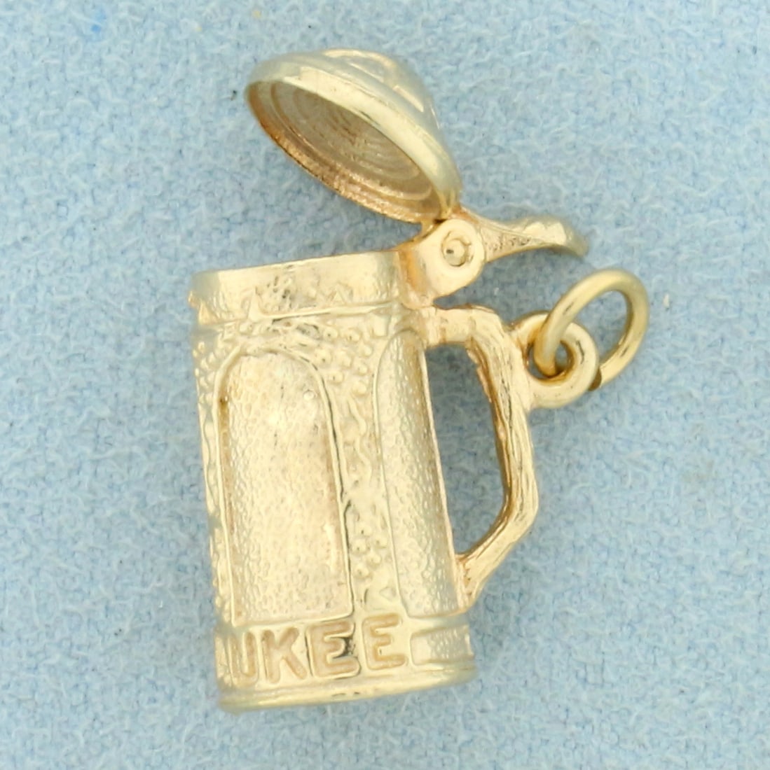 Milwaukee Beer Stein Pendant or Charm in 14K Yellow Gold: In 14K Yellow Gold. Lid opens/closes. 7/8 inch long. 7.4g.