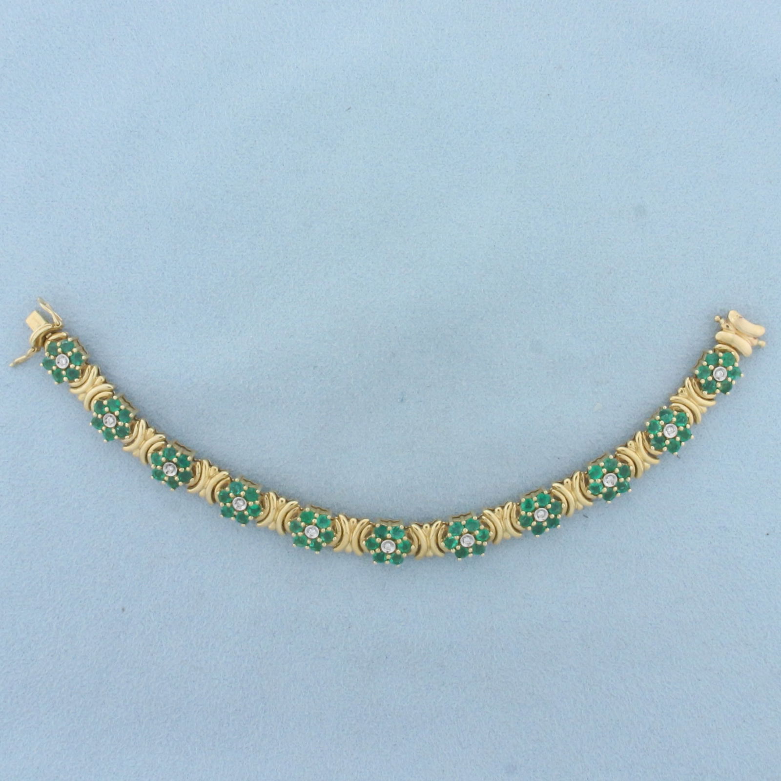 Vintage Emerald and Diamond Flower Design Bracelet in 14k Yellow Gold: In 14k yellow gold. Contains 66 high quality natural emeralds, approximately 5.5ct TW, with vibrant green color. Also contains 11 high quality .01ct diamonds, SI clarity/H color. 6 inches long, 8.5mm