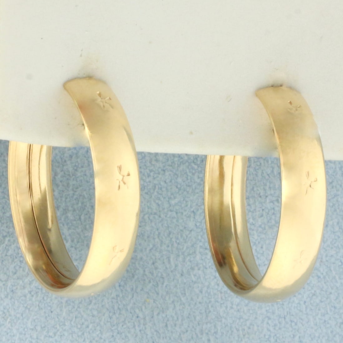 Star Design Engraved Hoop Earrings in 18k Yellow Gold: In 18k yellow gold. 7/8 inch diameter and 5mm wide. 5.6g.