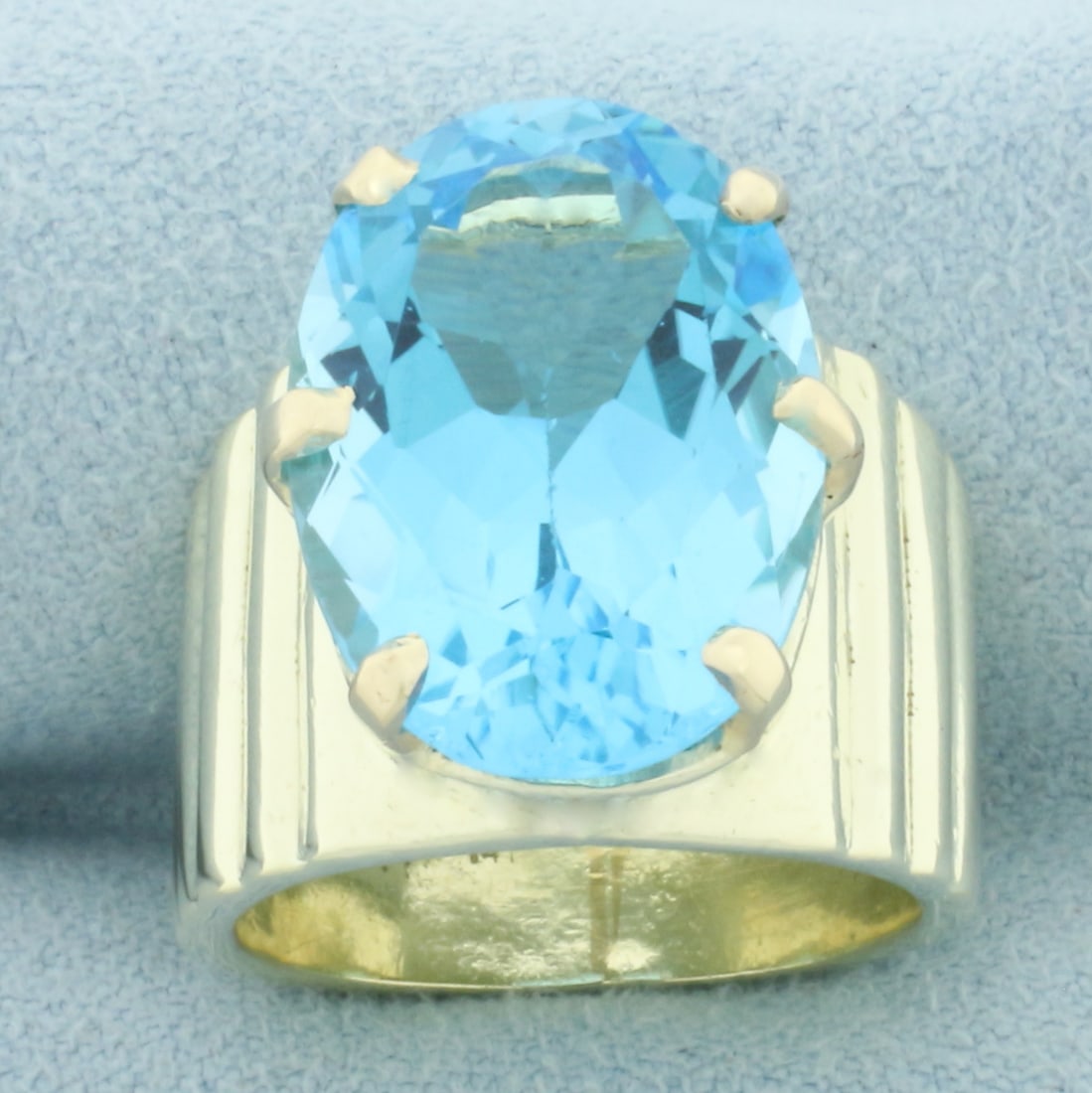 14ct Swiss Blue Topaz Statement Ring in 14k Yellow Gold: In 14k Yellow Gold. Contains one high quality natural 18mmx13mm Swiss Blue Topaz gemstone, approximately 14cts, with electric blue color and excellent clarity. Size 6. 16.4g.