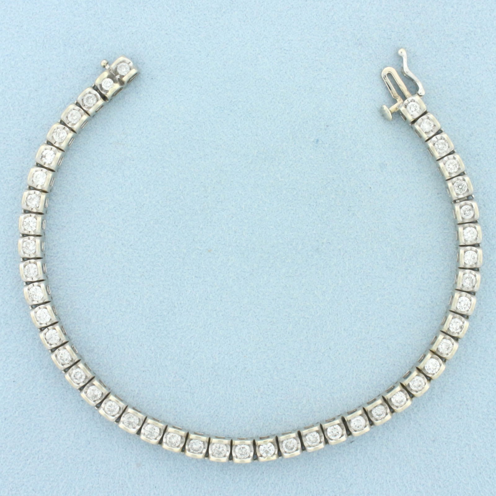 3ct Diamond Tennis Bracelet in 14k White Gold: In 14k White Gold. Contains forty-five high quality diamonds, 3ct TW, I clarity/I color, great cut for added brilliance. 7 3/8 inches long. 4mm wide. Concealed slide clasp with safety latch. 17.1g.