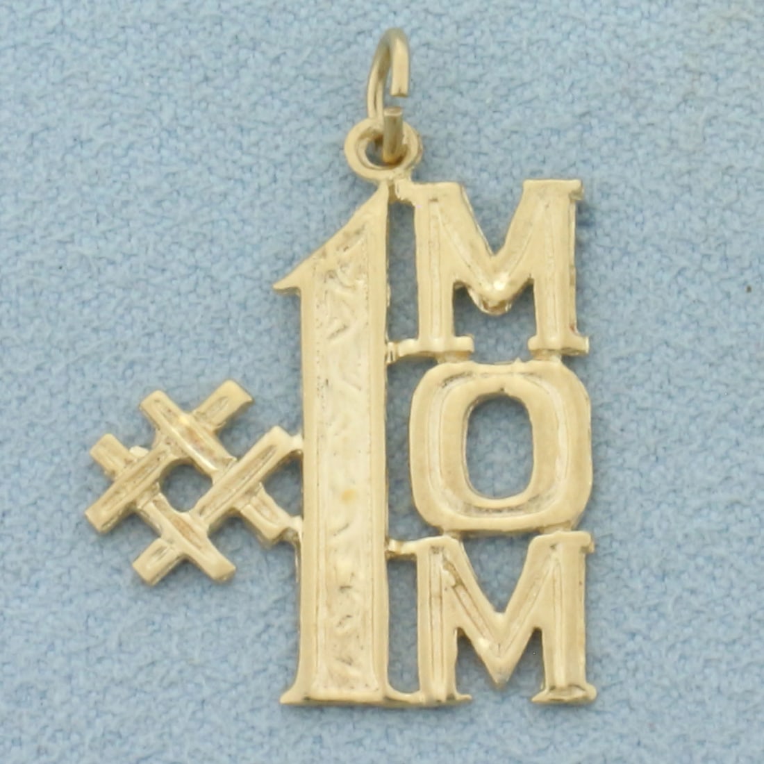 #1 Mom Charm or Pendant in 14k Yellow Gold: In 14k Yellow Gold. 1 inch long including jump ring. 3/4 inch wide. 1.7g.