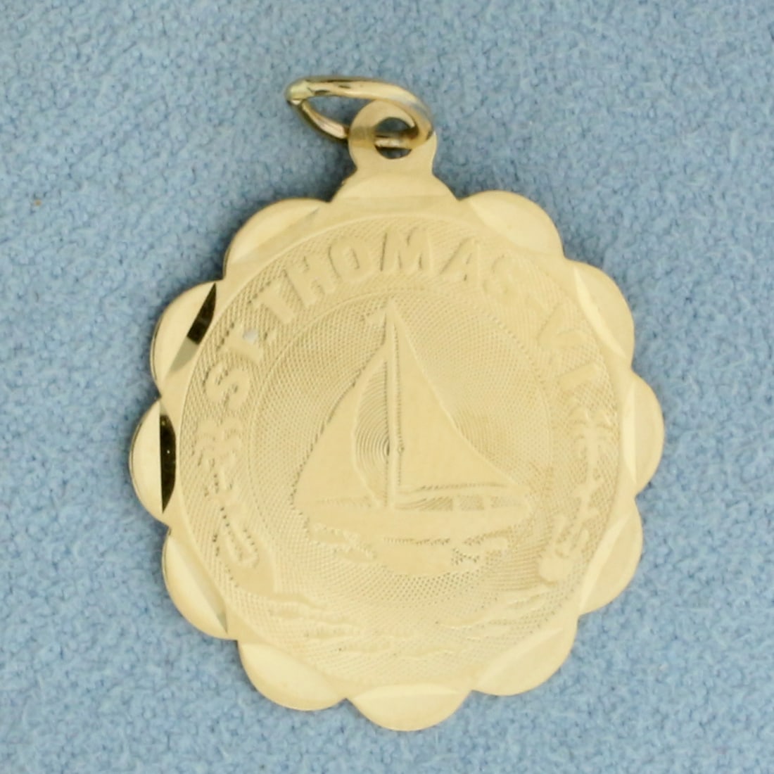 St. Thomas VI Sailboat Charm or Pendant in 14k Yellow Gold: In 14k Yellow Gold. 1 1/8 inches long including bale. 7/8 inch wide. 1.1g.