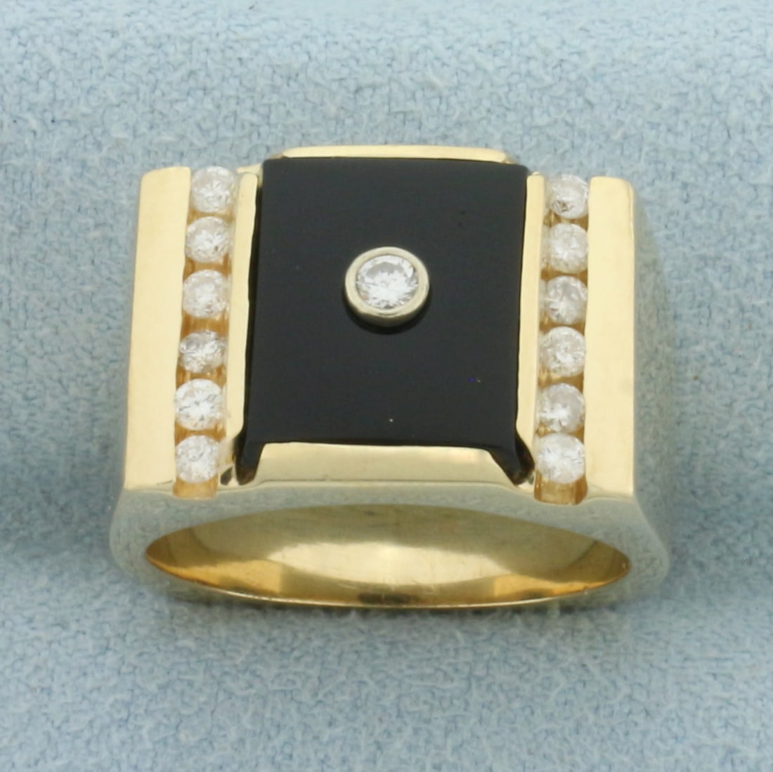 Vintage Onyx and Diamond Ring in 14k Yellow Gold: In 14k Yellow Gold. Contains one .04ct and twelve .03ct high quality diamonds, SI clarity/H color. 11.5x9.5mm Onyx plaque. 13mm wide at top. Size 7.25. 16.8g.
