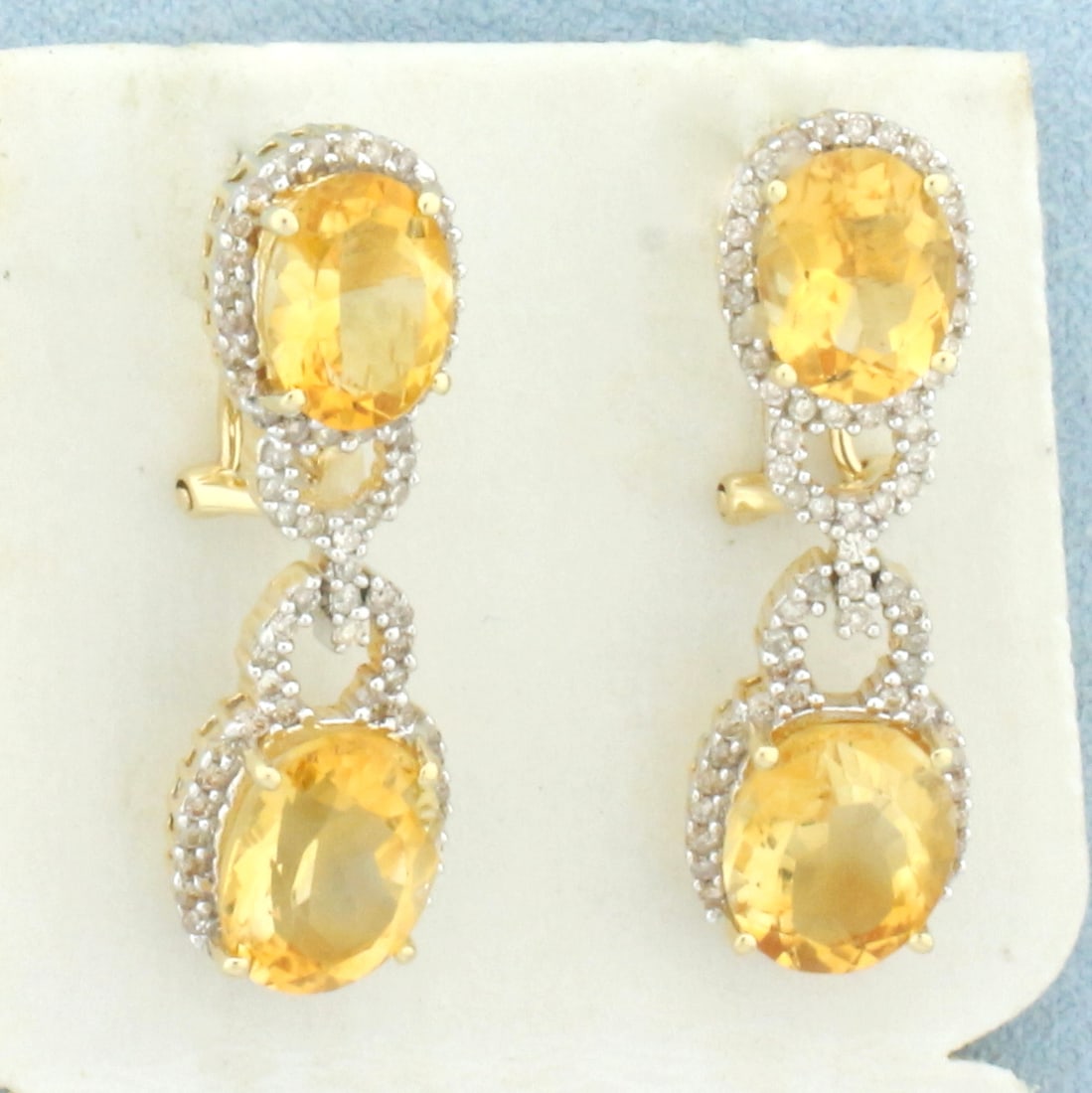Citrine and Diamond Dangle Earrings in 14k Yellow Gold: In 14k Yellow Gold. Contains two 10mm and two 9mm high quality oval cut natural Citrine gemstones with bright color and excellent clarity. Also contains one hundred and thirty-four high quality 1/2pt