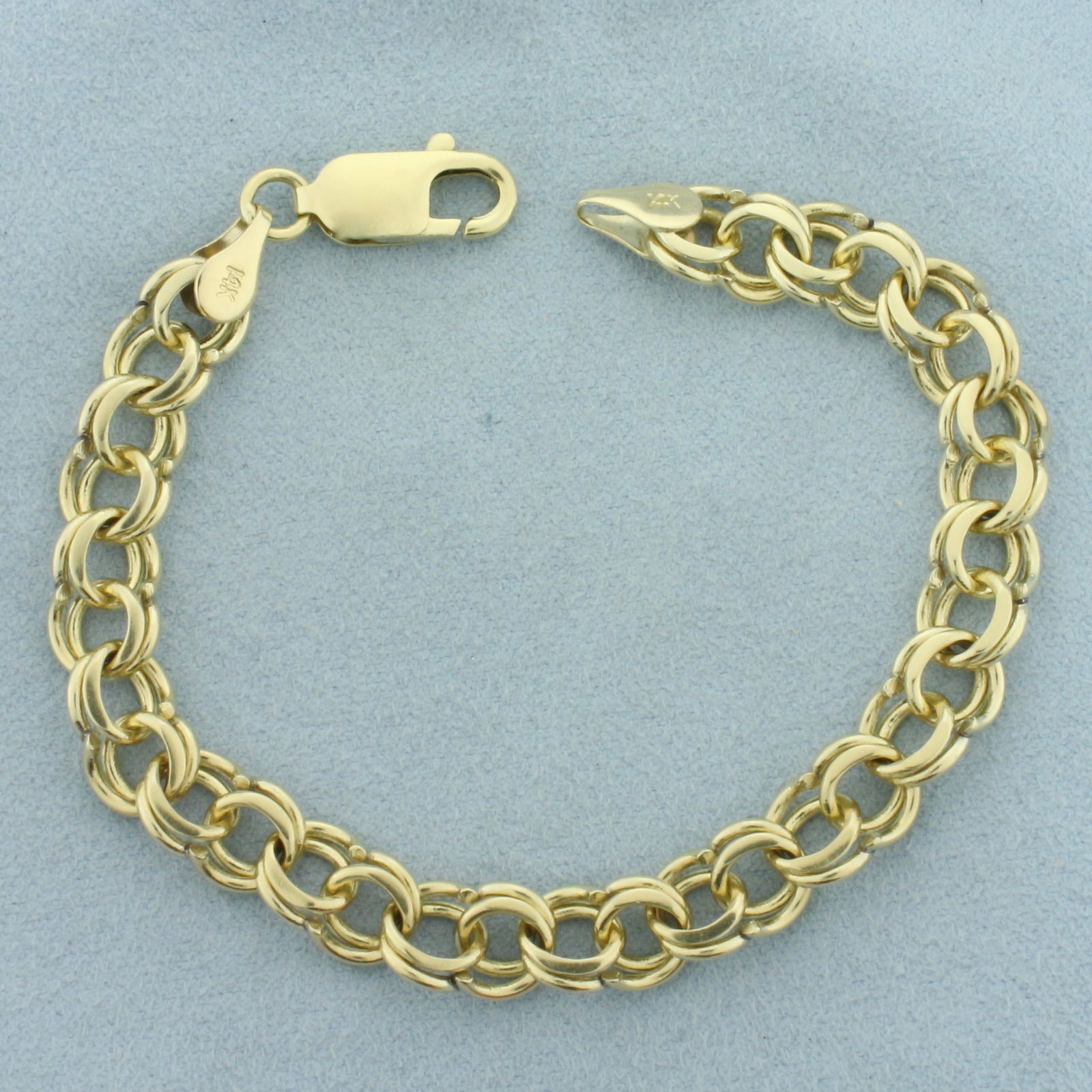 Double Loop Cable Link Charm Bracelet in 14k Yellow Gold: In 14k Yellow Gold. 7 1/4 inches long. 8mm wide. Lobster clasp. 16.8g.