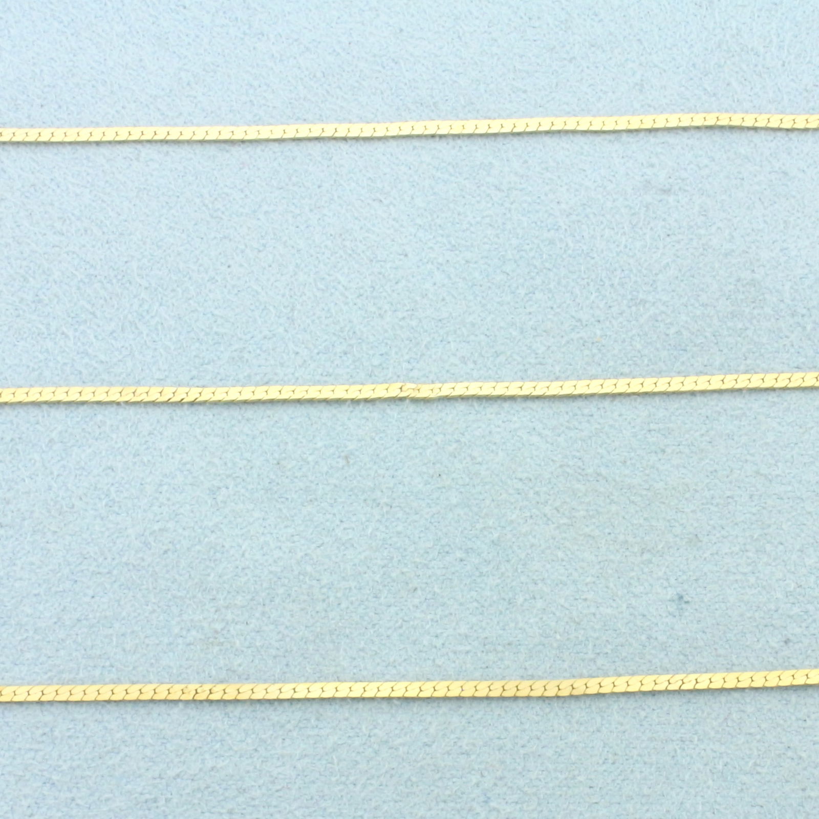 Italian 30 Inch Herringbone Link Chain Necklace in 14k Yellow Gold: In 14k Yellow Gold. 30 inches long. 1.5mm wide. Herringbone link. Made in Italy. Spring clasp. 3.3g.