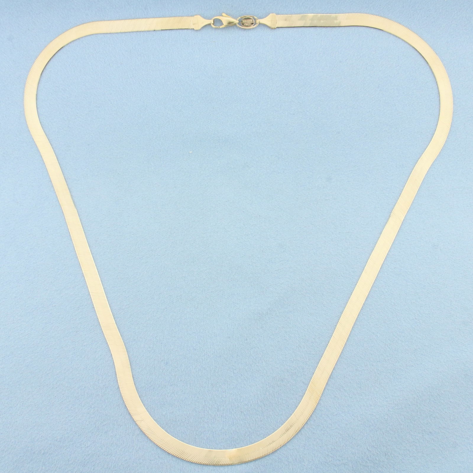 20 Inch Italian Liquid Gold Herringbone Link Chain Necklace in 14k Yellow Gold: In 14k Yellow Gold. 20 inches long. 4.8mm wide. Italian made. Lobster clasp. 10.1g.