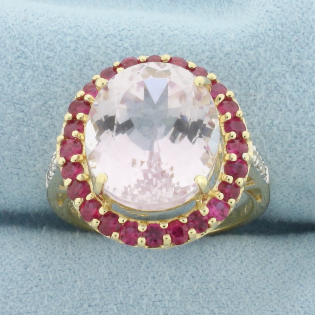 Kunzite Ruby and Diamond Halo Ring in 14k Yellow Gold: In 14k yellow gold. Contains one high quality 14x12mm Kunzite gemstone, approximately 9ct, with bright color and excellent clarity. Also contains twenty-four Ruby gemstones, 2mm each, with intense col