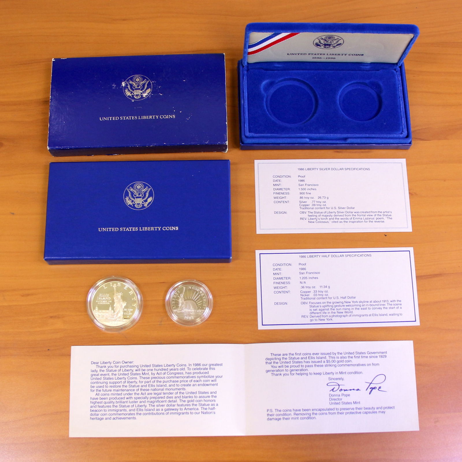 US Mint Silver Liberty Coin Set OGP: Contains one 1986 Liberty Silver Dollar and one 1986 Liberty Half Dollar. Set in original government packaging and contains certificate of authenticity.