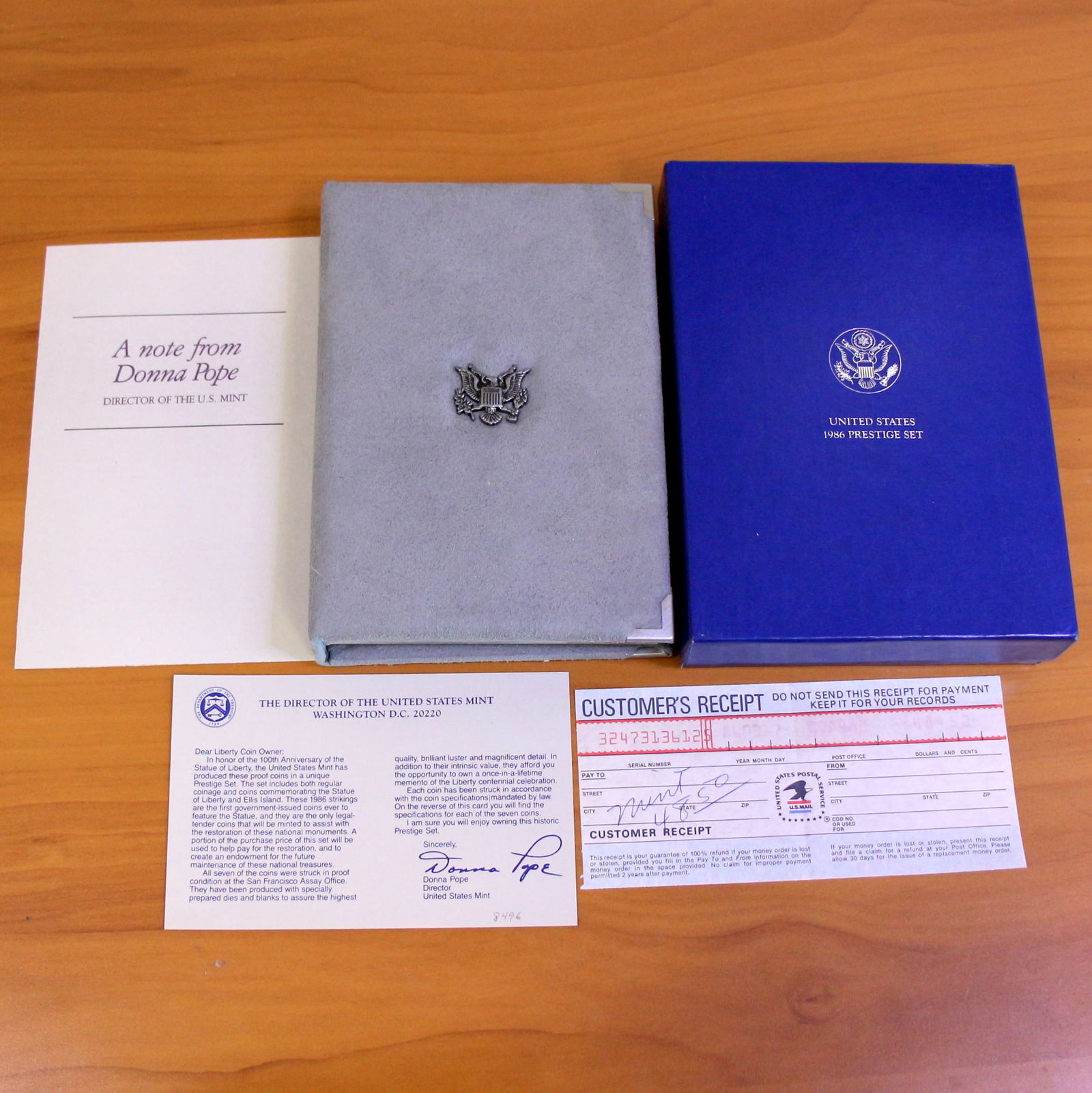 US Mint Liberty Prestige Coin Set OGP: 1986 United States Mint Prestige Set which including one 1986 90% Silver Liberty Silver Dollar. Set in original packaging and contains certificate of authenticity and original order receipt.