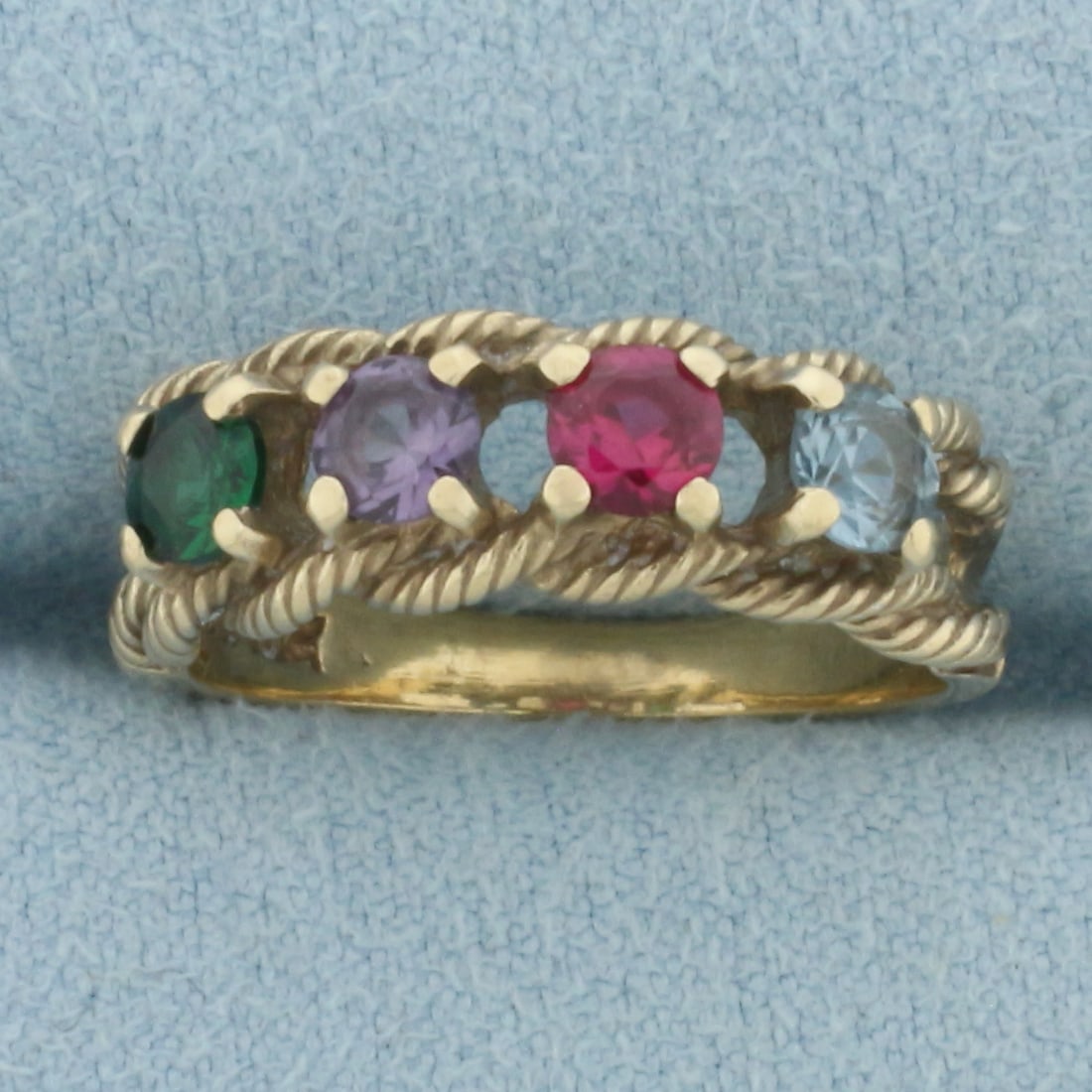 Rainbow Topaz Rope Design Ring in 10k Yellow Gold: In 10k Yellow Gold. Contains four 3.7mm high quality Topaz gemstones with vibrant color and excellent clarity. 6.4mm wide. Size 6.25. 3.2g.