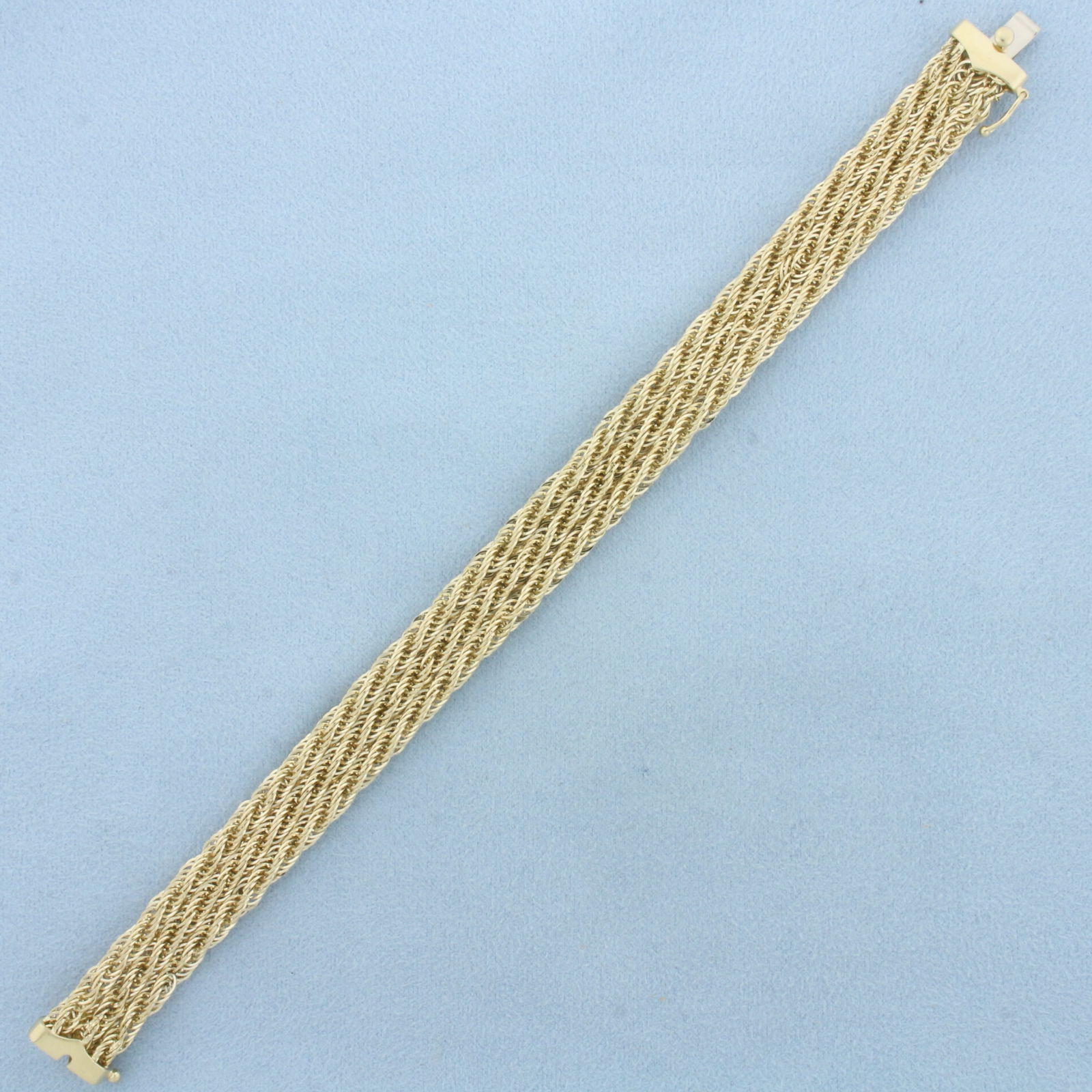 Wide Triple Rope Link Bracelet in 14k Yellow Gold: In 14k Yellow Gold. 7 3/8 inches long. 10.8mm wide. Slide clasp with safety latch. 9.1g.