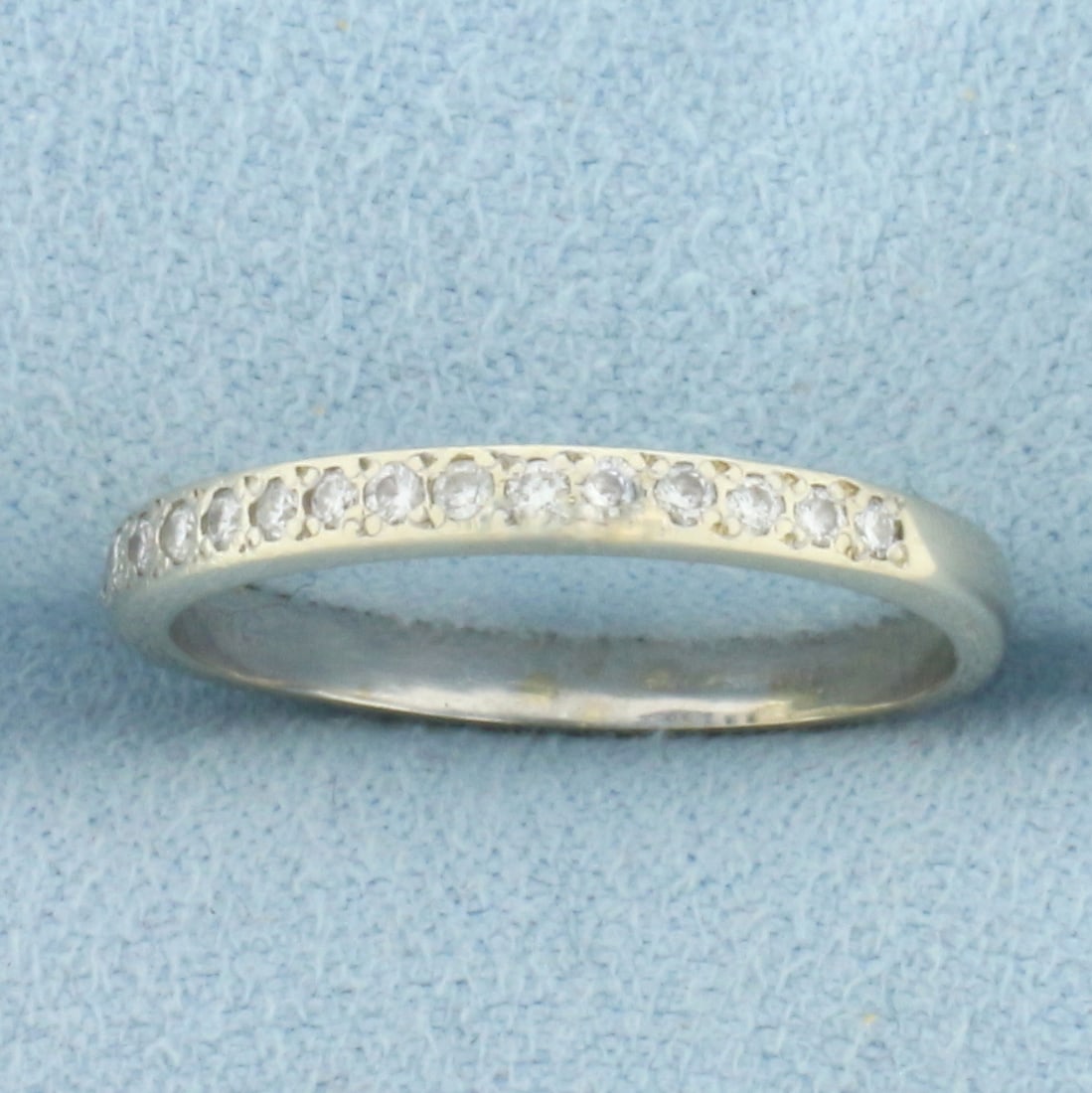 Maison Birks Designer Diamond Band Ring in 18k White Gold: In 18k Yellow Gold. Contains fifteen high quality .01ct diamonds. 2.2mm wide. Size 7. 2.2g.