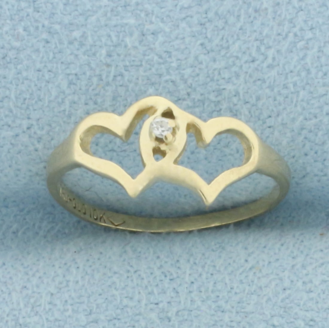 Diamond Two Hearts Ring in 10k Yellow Gold: In 10k Yellow Gold. Contains one high quality .01ct diamond. 6.6mm wide at widest spread. Size 3. .8g.