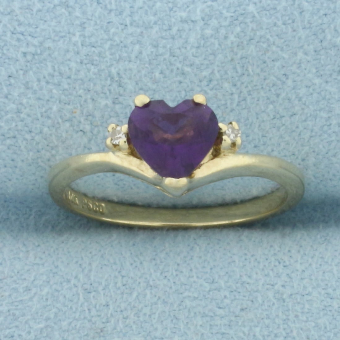 Heart Amethyst and Diamond Ring in 10k Yellow Gold: In 10k Yellow Gold. Contains one 6mm high quality heart shaped natural Amethyst gemstone with intense color and excellent clarity. Also contains two high quality .01ct diamonds. Size 5.75. 1.9g.