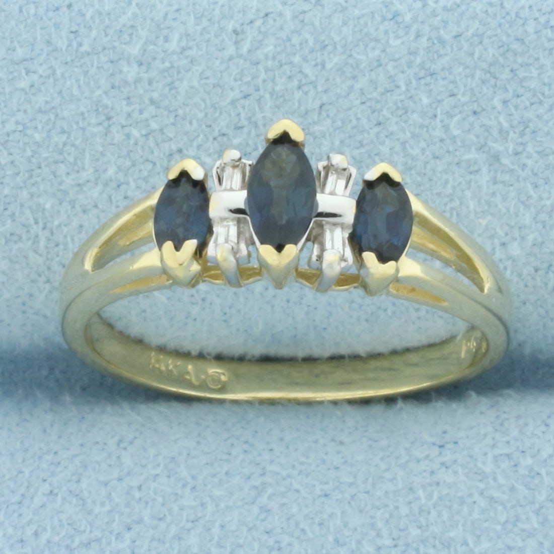 Sapphire and Diamond Split Shank Ring in 14k Yellow Gold: In 14k yellow gold. Contains one 6mm and two 5mm high quality natural marquise shaped Sapphire gemstones with intense color and excellent clarity. Also contains four high quality 2mm baguette diamonds