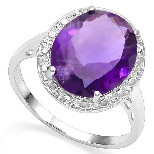 Vintage Style Large Amethyst and Diamond Ring in Sterling Silver: In platinum over .925 sterling silver. Contains one 4.3ct amethyst gemstone accented with two genuine diamonds, .01ctw. Size 7. 2.7g