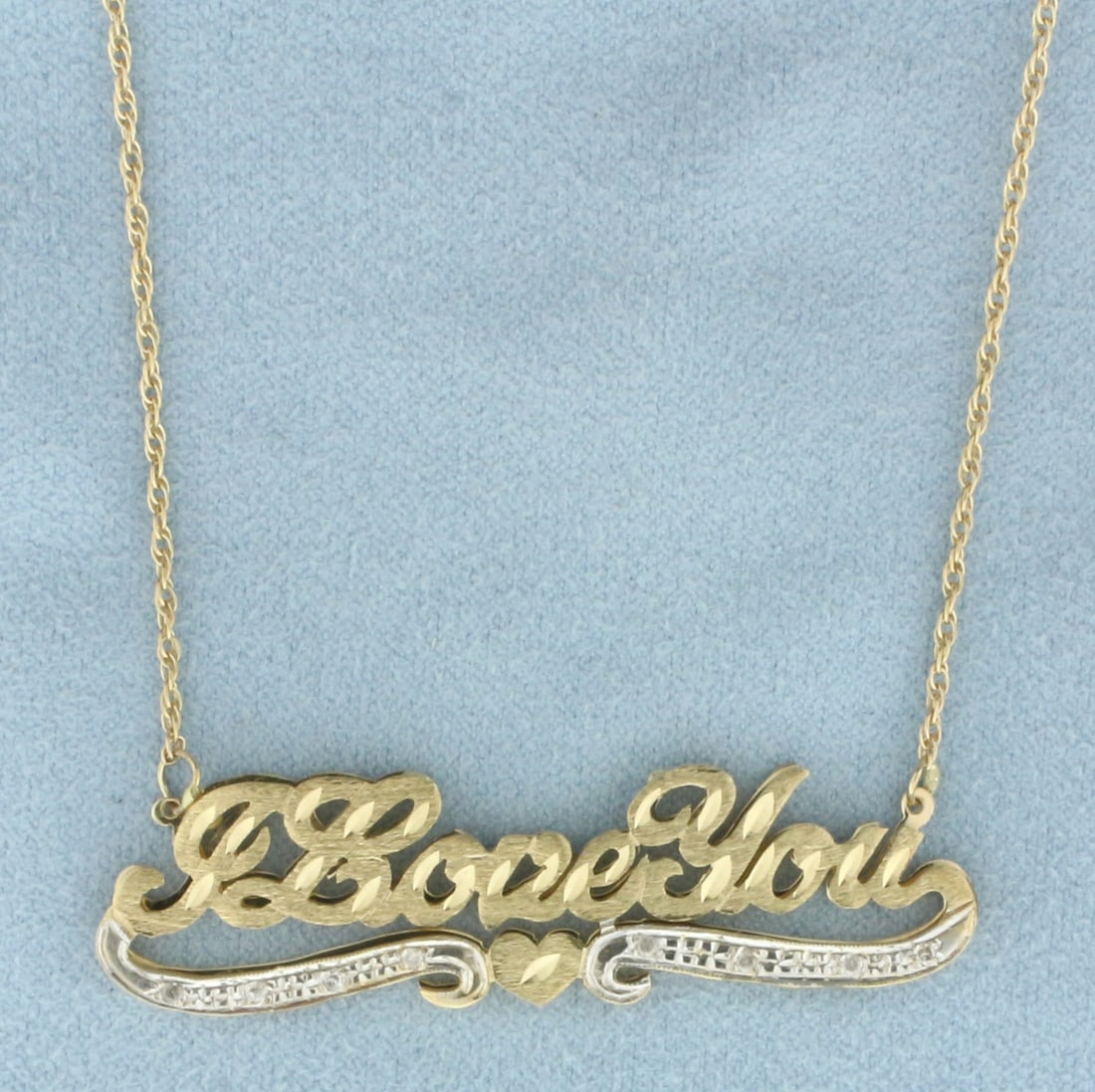 I Love You Diamond Necklace in 14k Yellow Gold: In 14k yellow gold. Contains eight high quality .01ct diamonds. 20 inches long. Chain is 1.25mm wide with spring clasp. Center is 2 1/8 inches wide by 1/2 inches high. 7.8g.