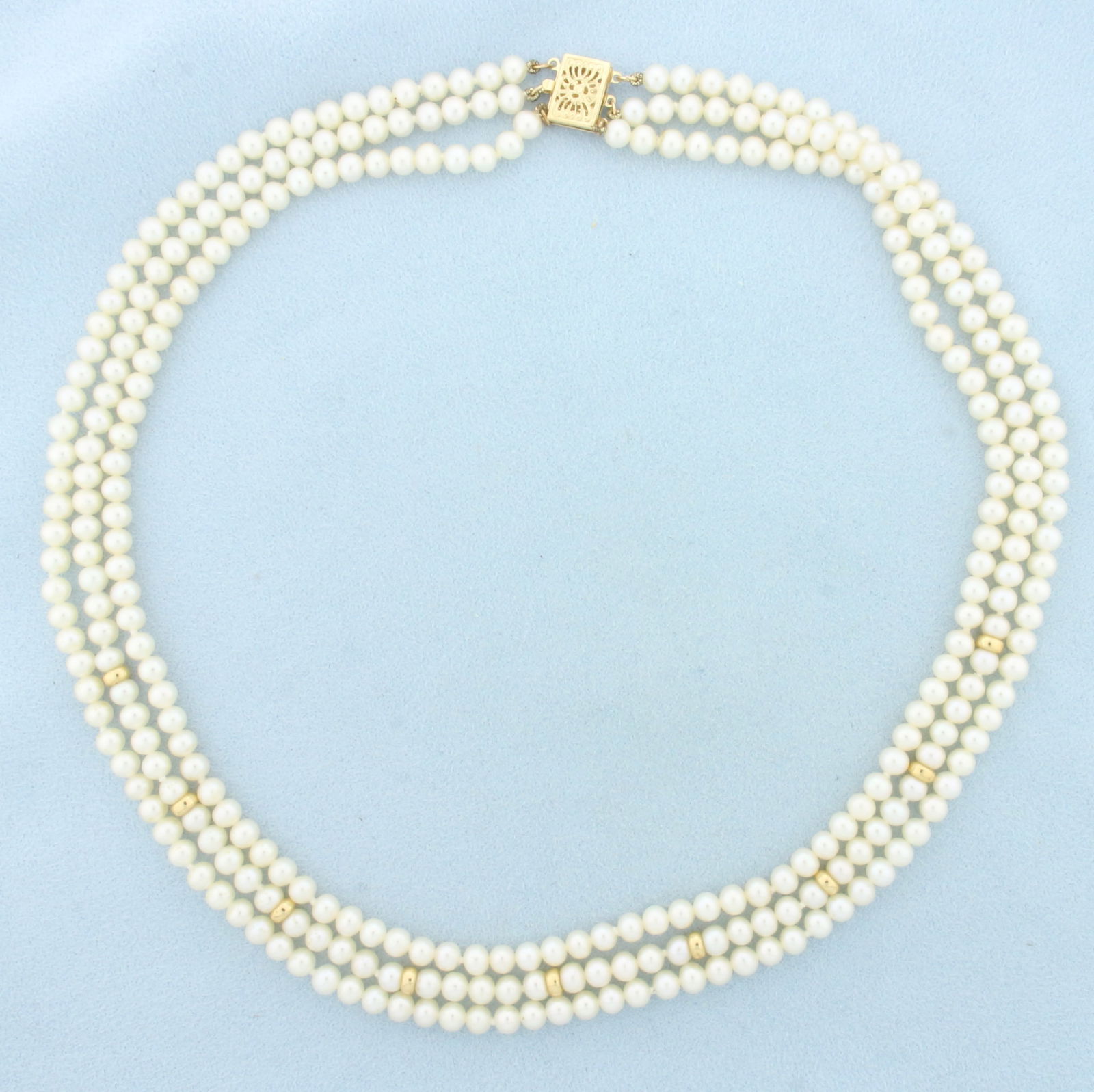 Triple Strand Pearl and Gold Bead Necklace in 14k Yellow Gold: In 14k Yellow Gold Clasp and Beads. Contains high quality 4.25-4.5mm pearls with high luster. 4.1mm gold beads. Shortest strand in 16 inches long. Hand knotted.