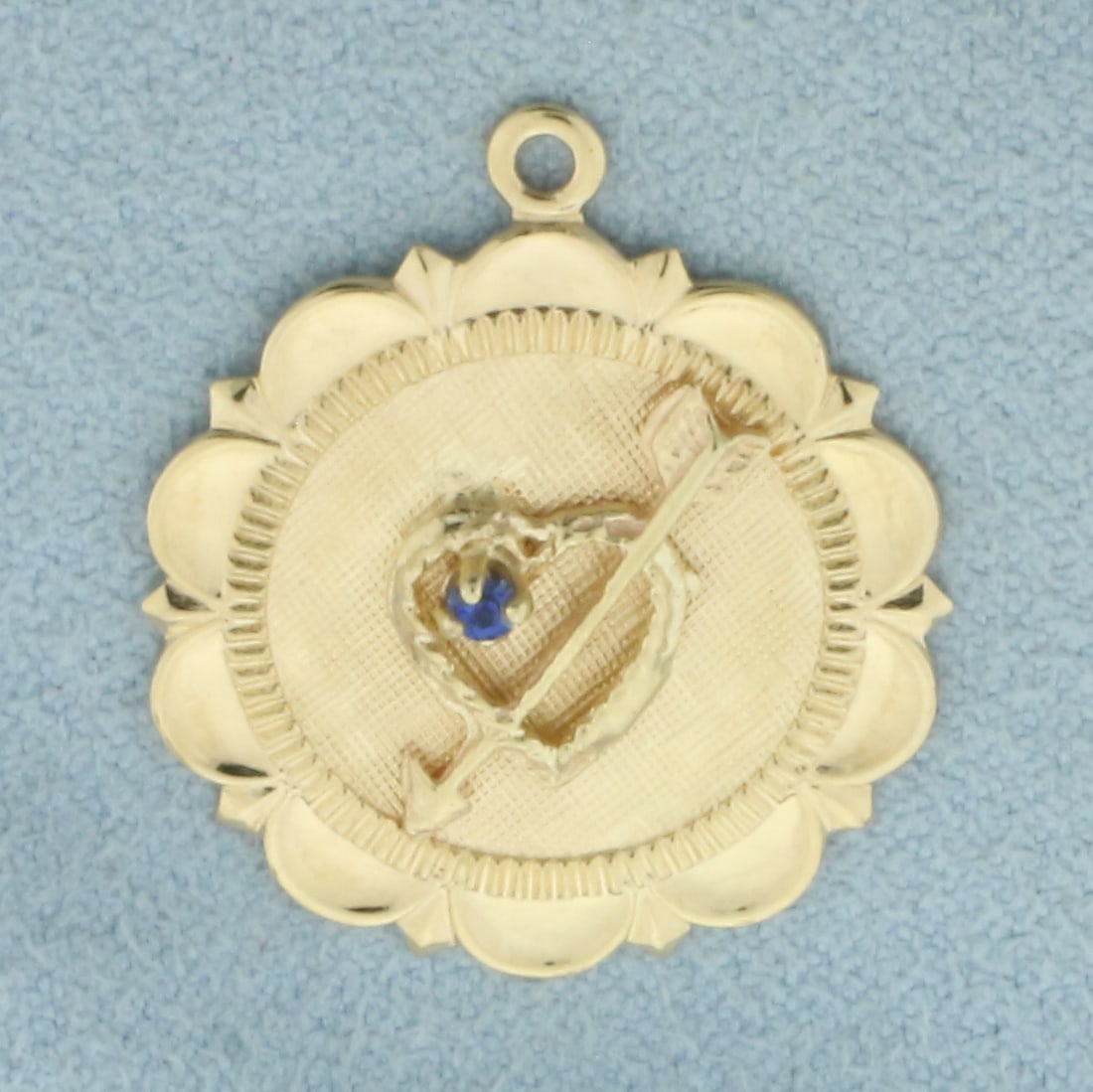 Inscribable Sapphire Arrow Through Heart Pendant or Charm in 14k Yellow Gold: In 14k Yellow Gold. Contains one high quality 2mm Sapphire gemstone with intense color and excellent clarity. 1 inch long. 7/8 inch wide. 2.7g.