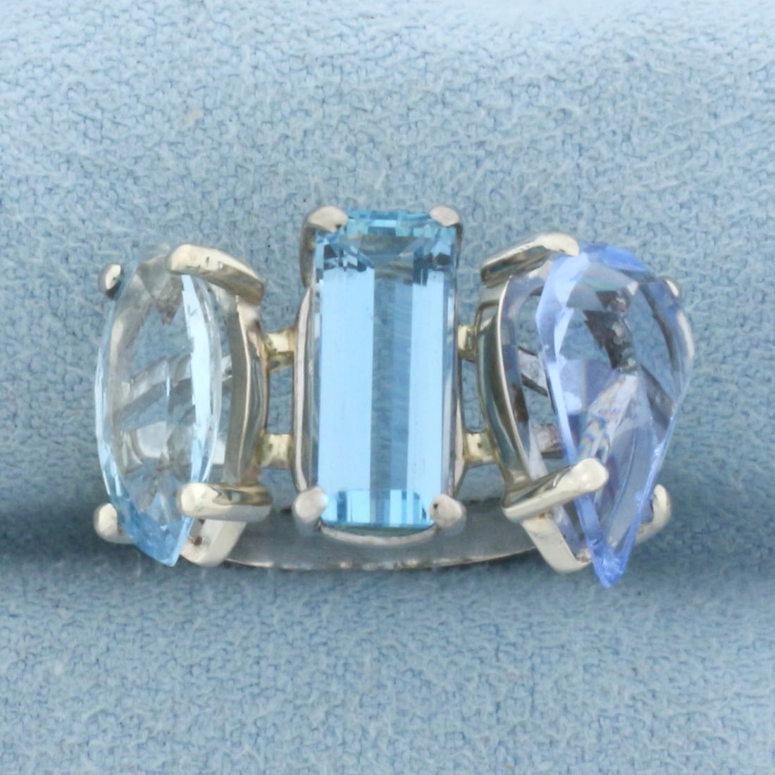 Aquamarine Three Stone Ring in 18k White Gold: In 18k White Gold. Contains one 12.5mmx5.75m, 1ct marquise, one 11.5mmx4.75mm 1.25ct emerald, and one 12.75mmx7.5mm 2ct pear cut high quality natural aquamarine gemstones with bright color and excelle