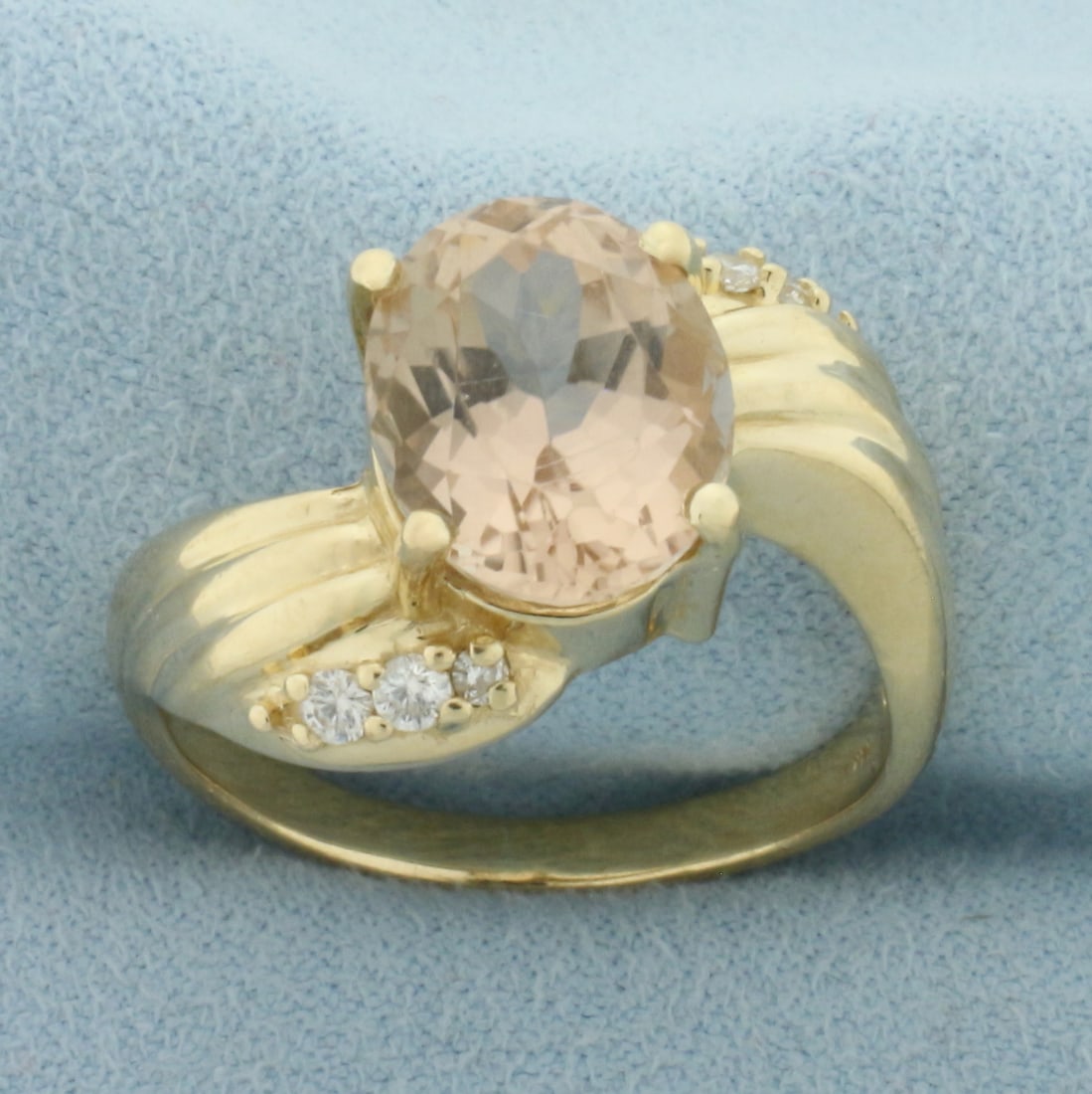 Morganite and Diamond Ring in 14k Yellow Gold: In 14k Yellow Gold. Contains one high quality 7ct Morganite gemstone with beautiful salmon color and excellent clarity. Also contains four .02ct and two .01ct high quality diamonds SI clarity/H color.