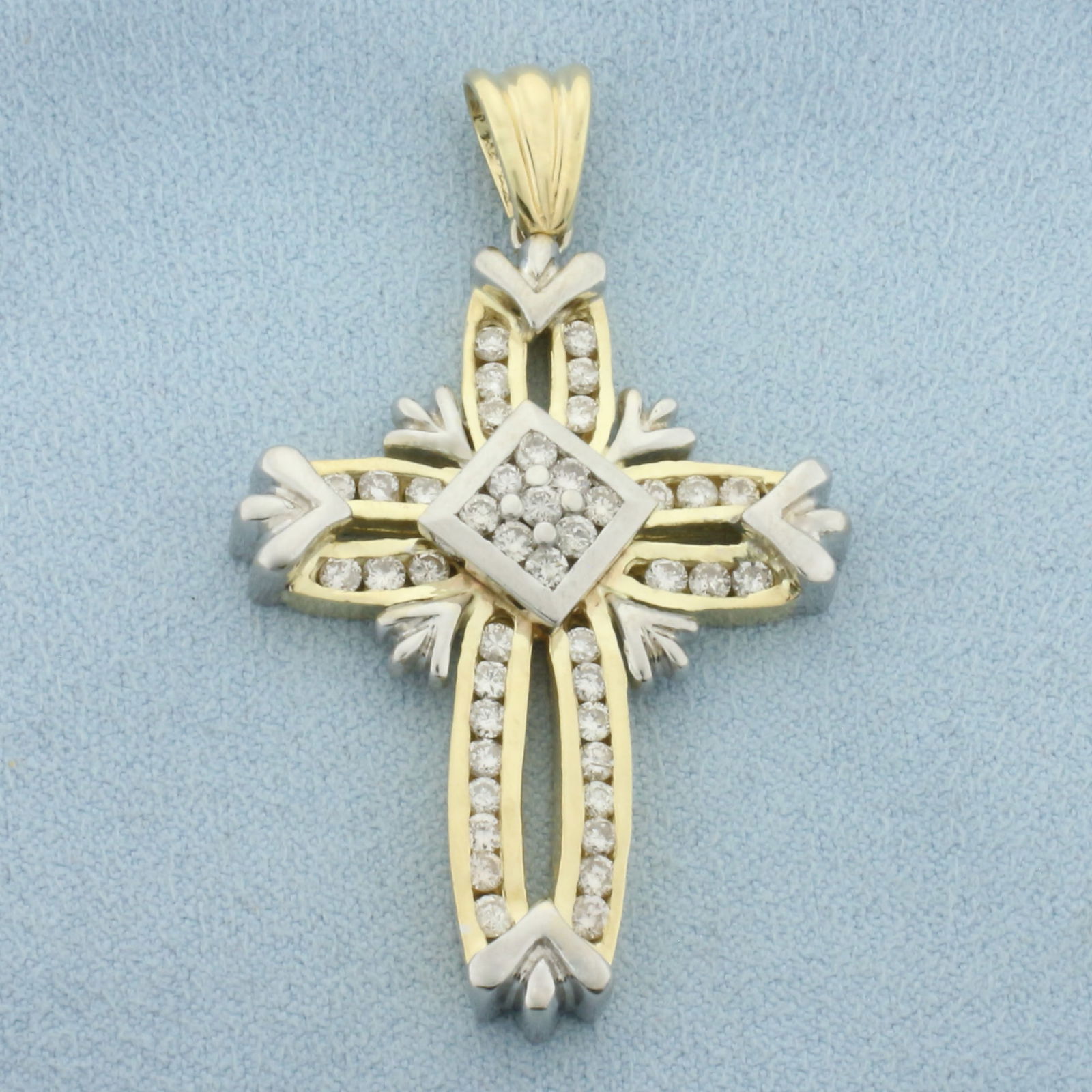 Unique Large Diamond Cross Pendant in 14k Yellow and White Gold: In 14k Yellow and White Gold. Contains forty-three high quality .03ct diamonds, 1.3ct TW, I color/I clarity. 2 inch long including bail. 1 1/4 inch wide. 21.1g.