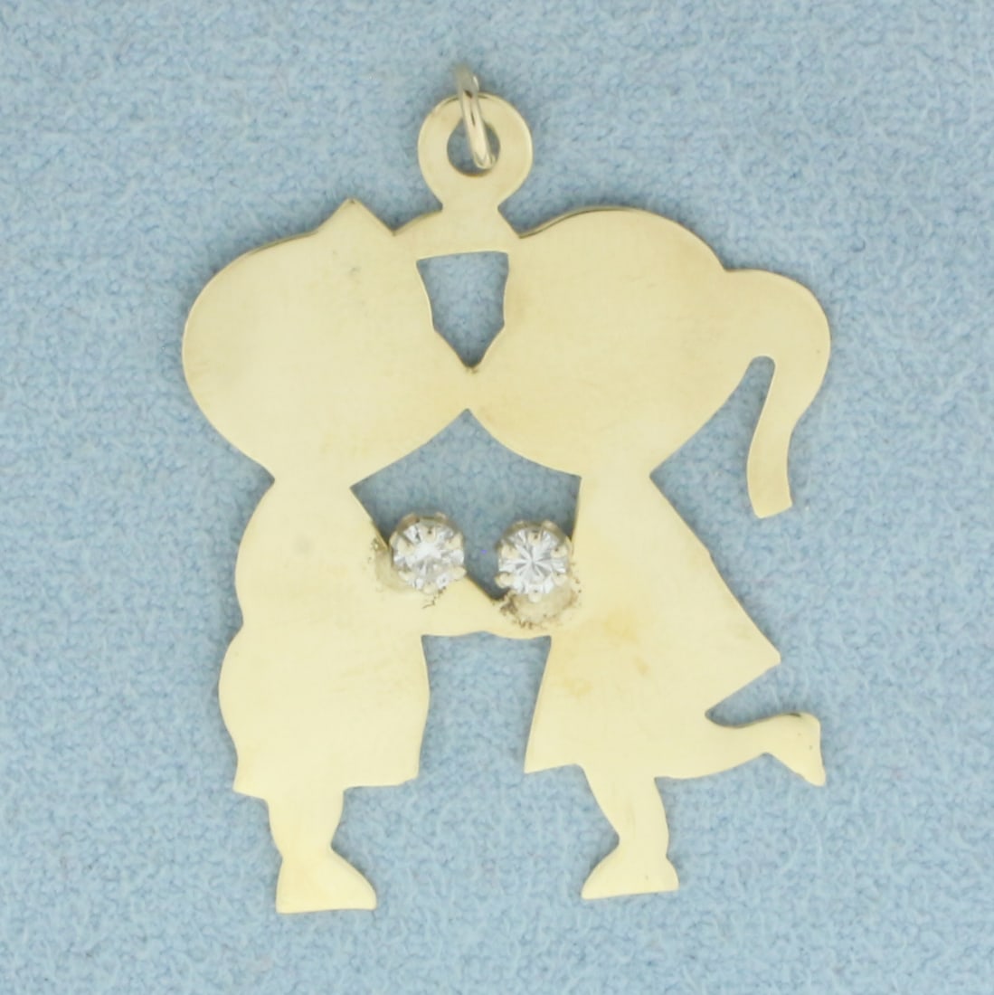 Engravable Boy and Girl Kissing Love Diamond Pendant or Charm in 14k Yellow Gold: In 14k Yellow Gold. Contains two .05ct high quality diamonds, VS clarity/F color. 1 1/4 inch long. 1 inch wide. Can engrave name or date on either side. 2.0g.