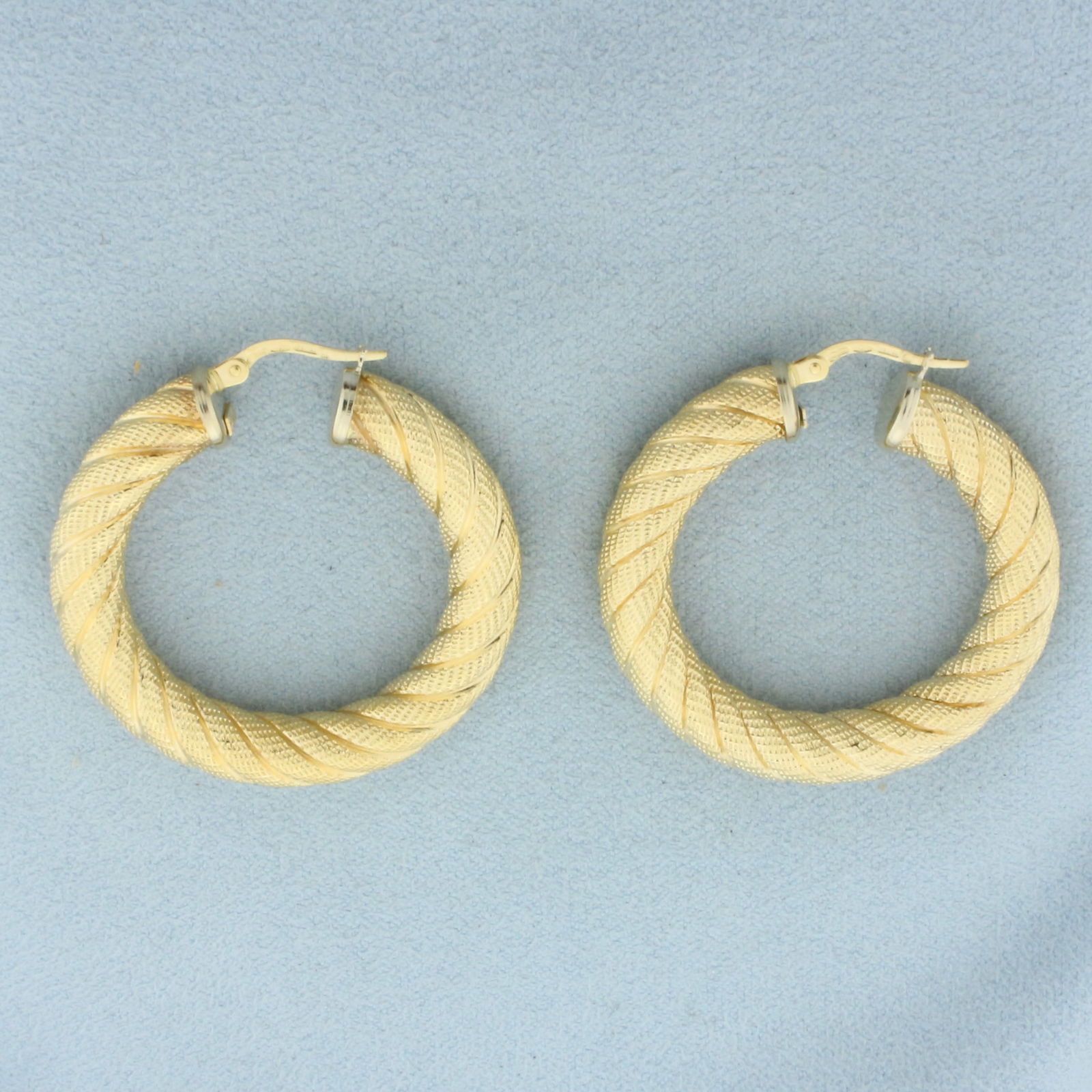 Italian Rope Hoop Earrings in 18k Yellow Gold: In 18k Yellow Gold. 1 3/8 inch diameter. 6mm wide. Italian made. Leverbacks. 11.0g.